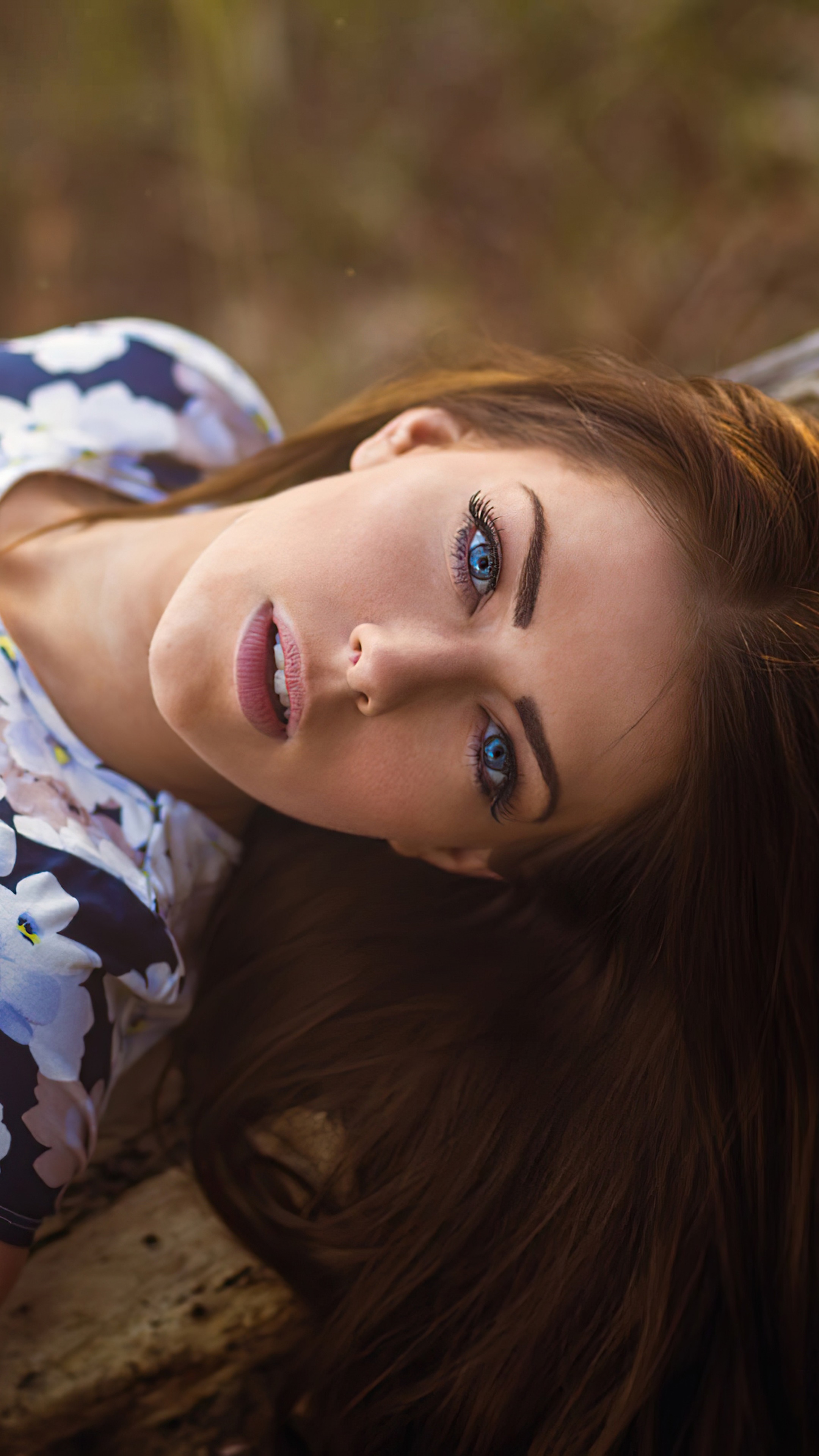 Woman with blue eyes and floral shirt HD Phone Wallpaper