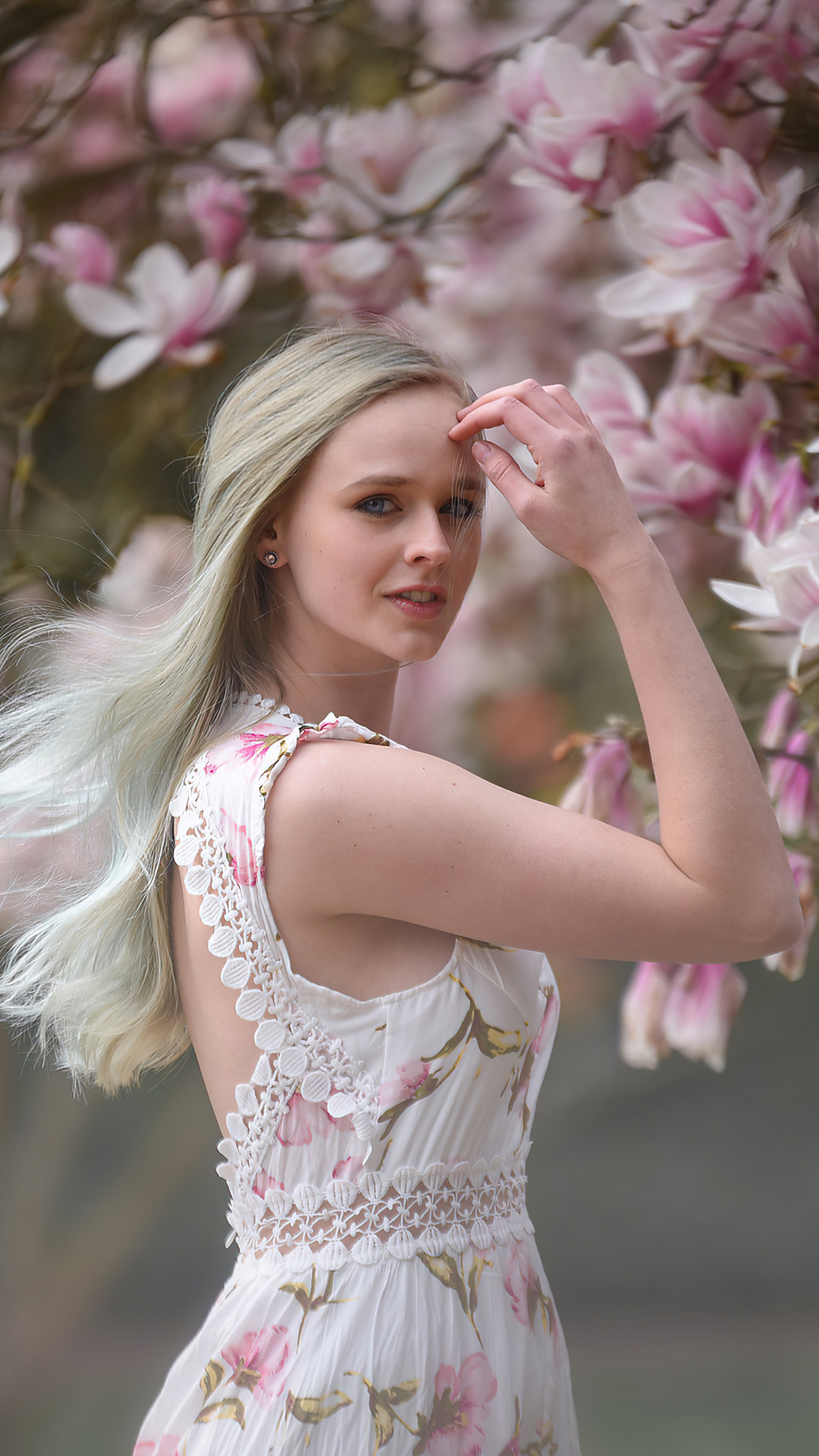 Woman in floral dress with pink magnolia flowers HD Phone Wallpaper