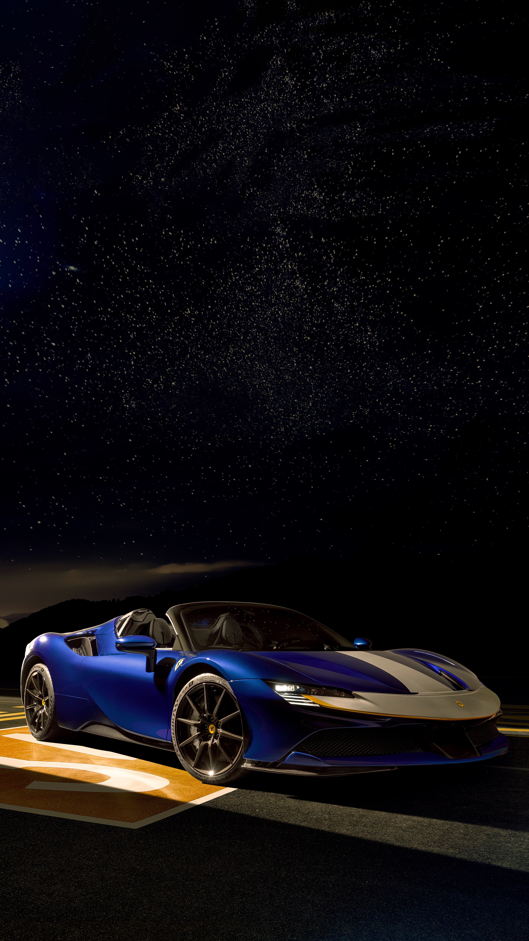 Blue Ferrari SF90 Spider convertible under starry night sky HD Phone Wallpaper
