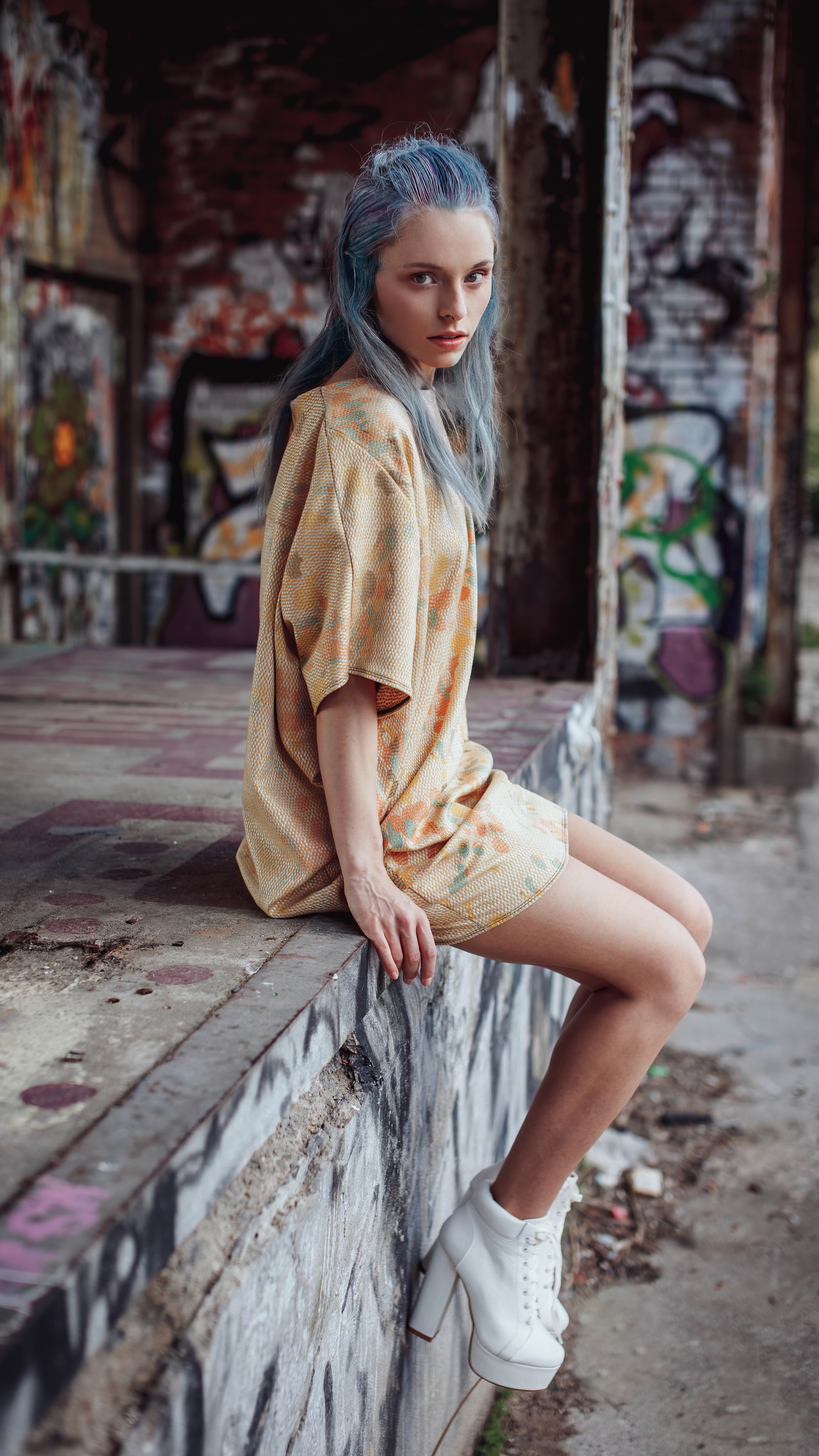 Model with blue hair in a graffiti-covered building HD Phone Wallpaper