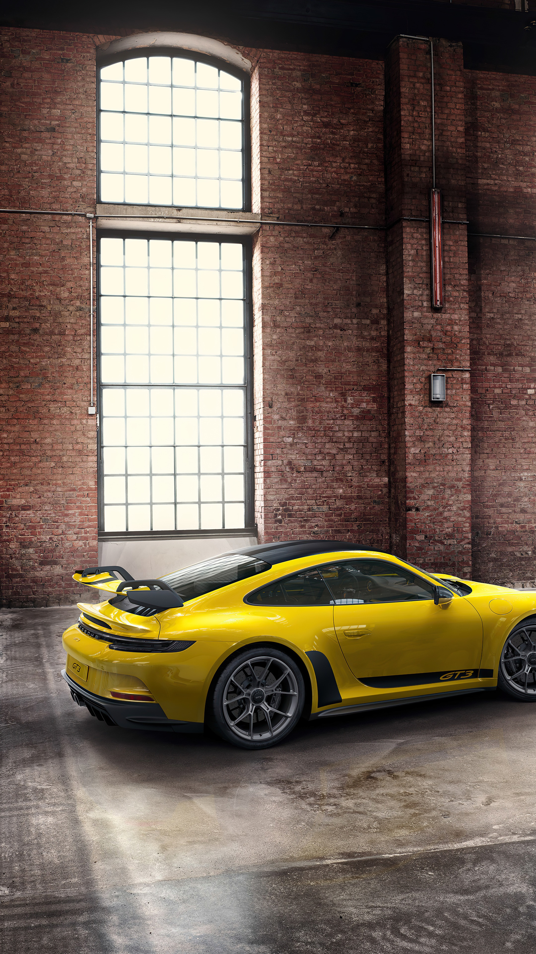 Yellow Porsche 911 GT3 RS in brick building HD Phone Wallpaper