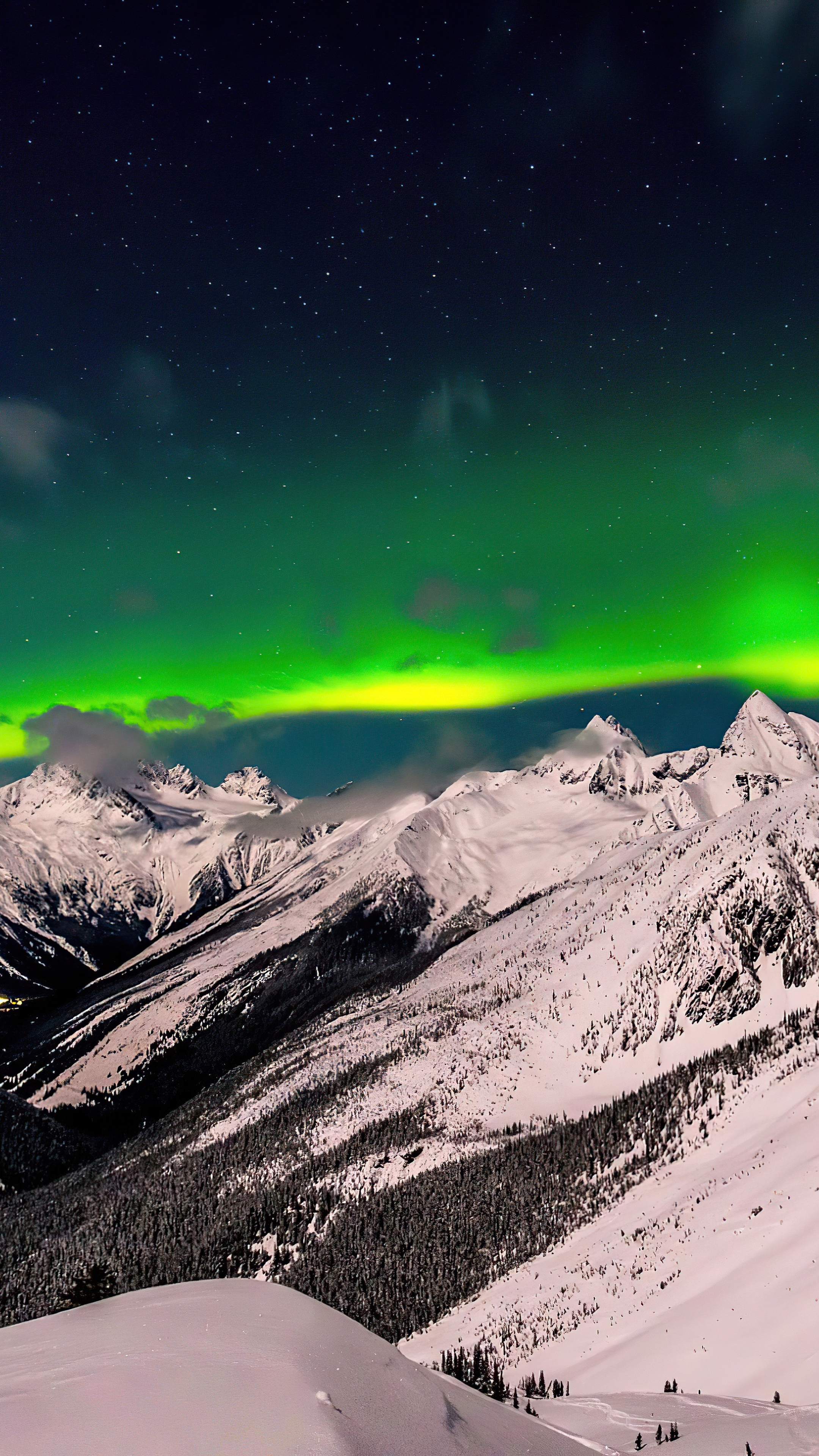 Aurora Borealis over snow-covered mountains HD Phone Wallpaper