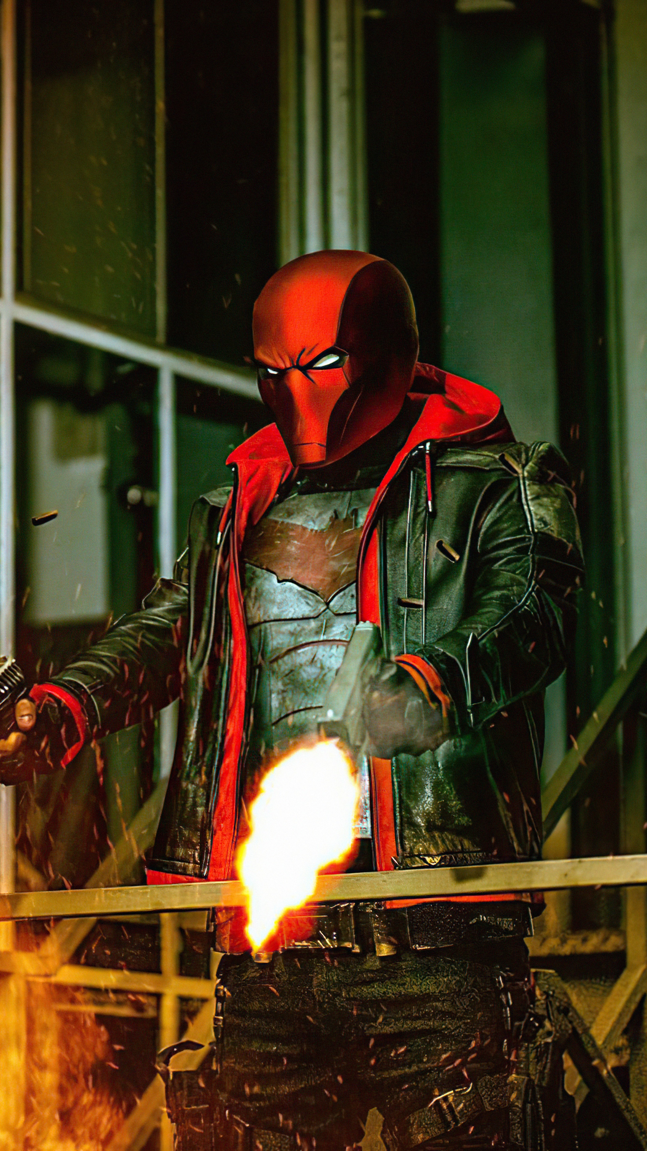 Red Hood firing a gun with flames HD Phone Wallpaper