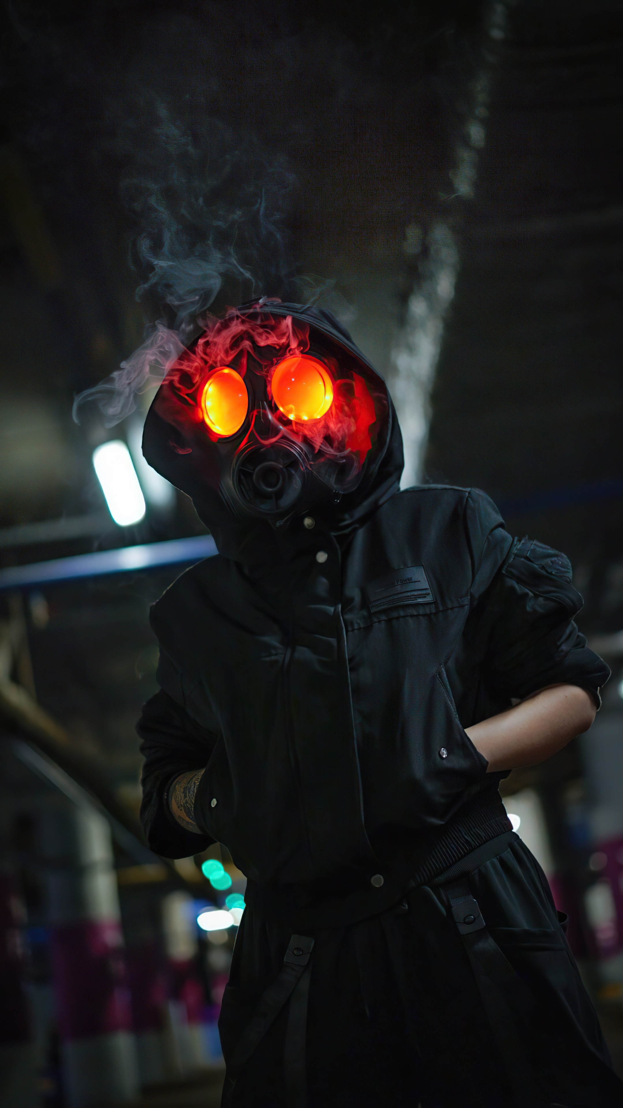 Person in gas mask with glowing eyes and hoodie HD Phone Wallpaper