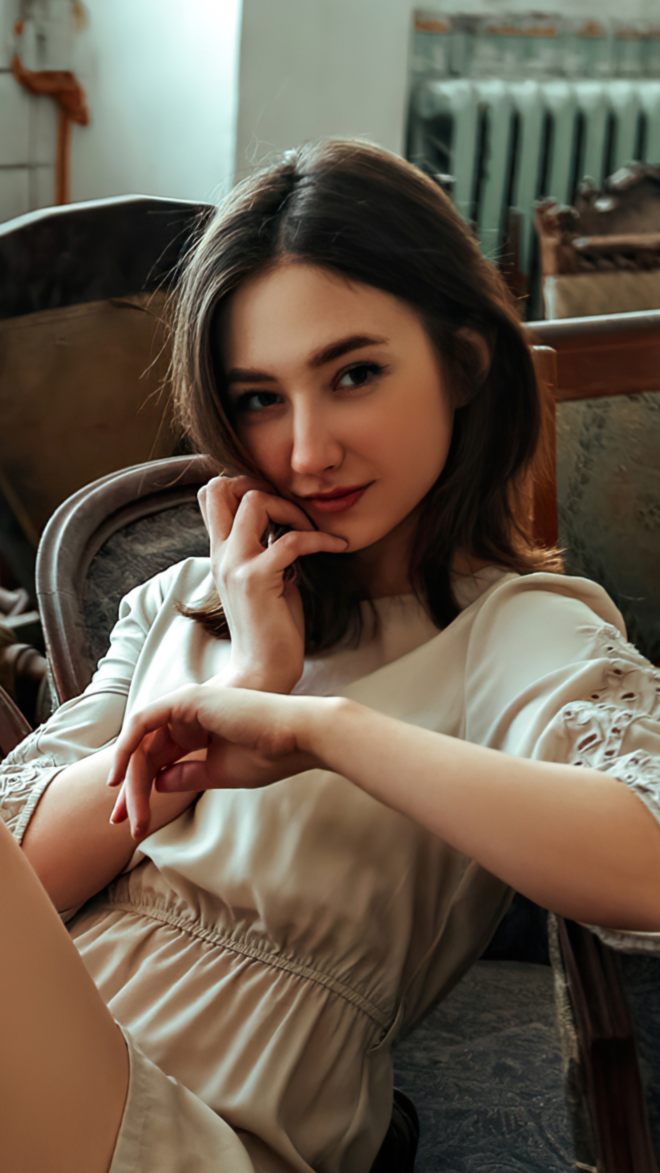 Brunette model posing in a chair HD Phone Wallpaper