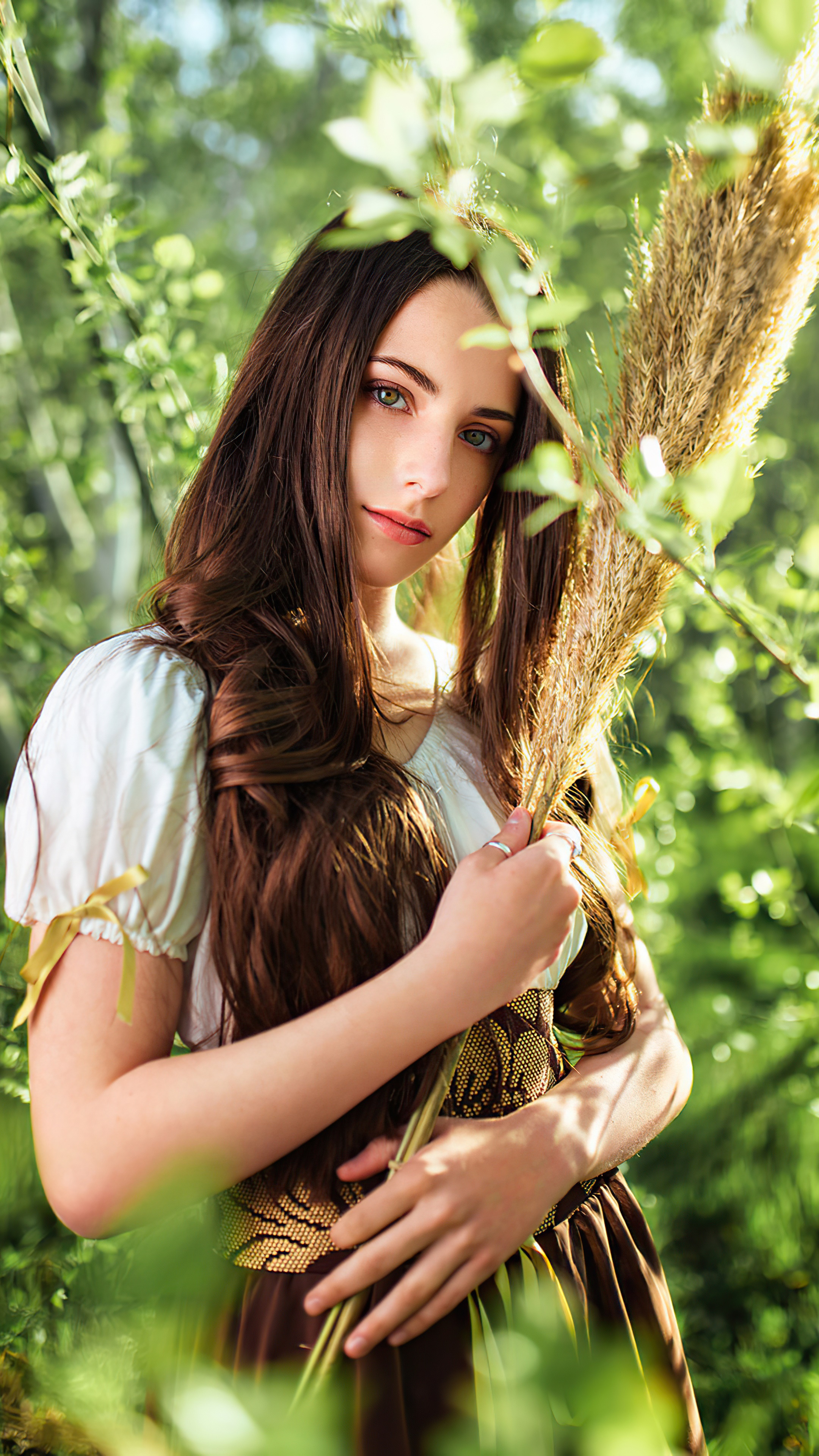Girl with long brown hair holding reeds HD Phone Wallpaper