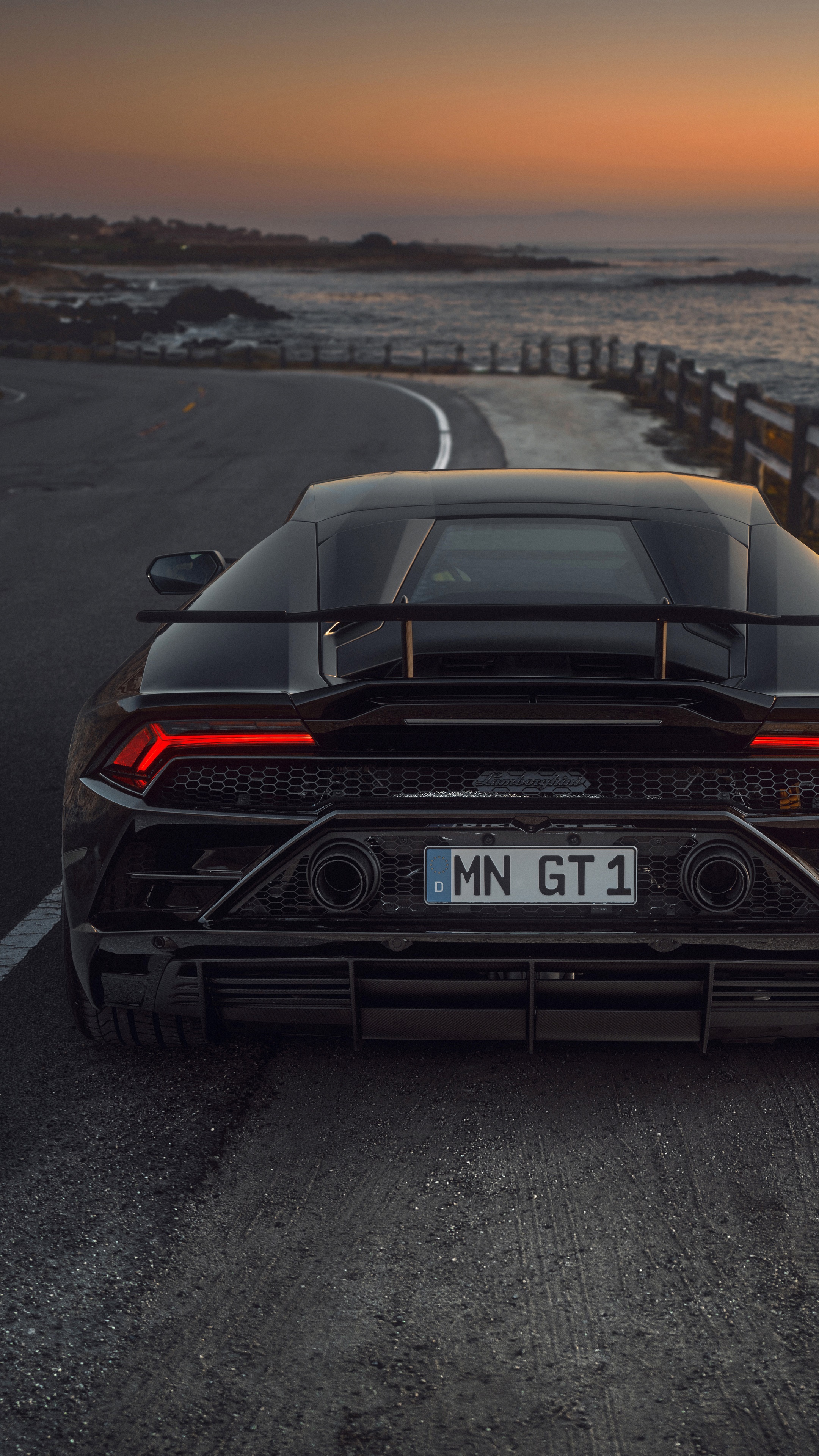 Black Lamborghini Huracan Evo on a coastal road at sunset HD Phone Wallpaper