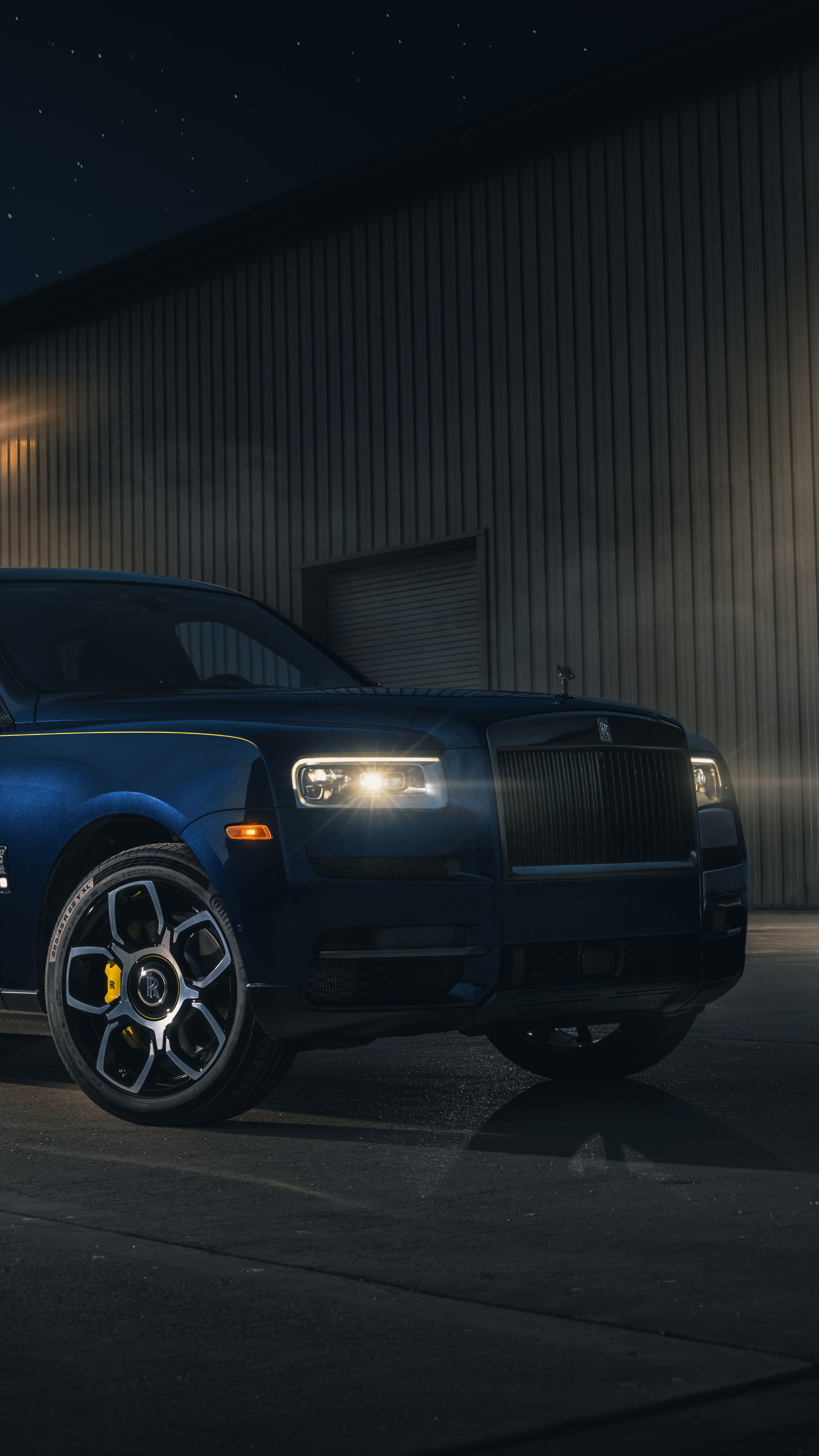 Rolls Royce Cullinan parked outside a building at night HD Phone Wallpaper