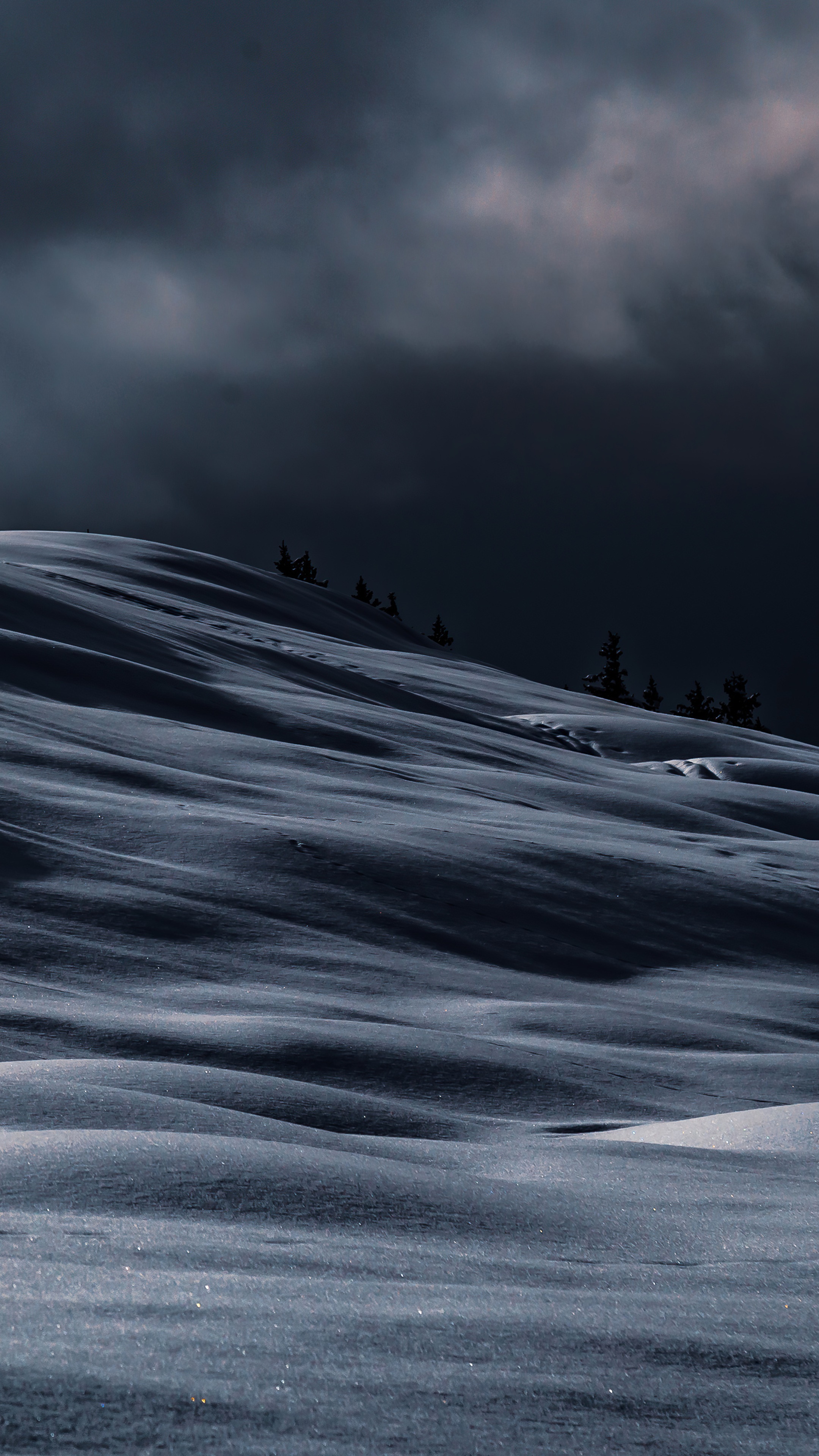 Snowy hills under dark clouds HD Phone Wallpaper