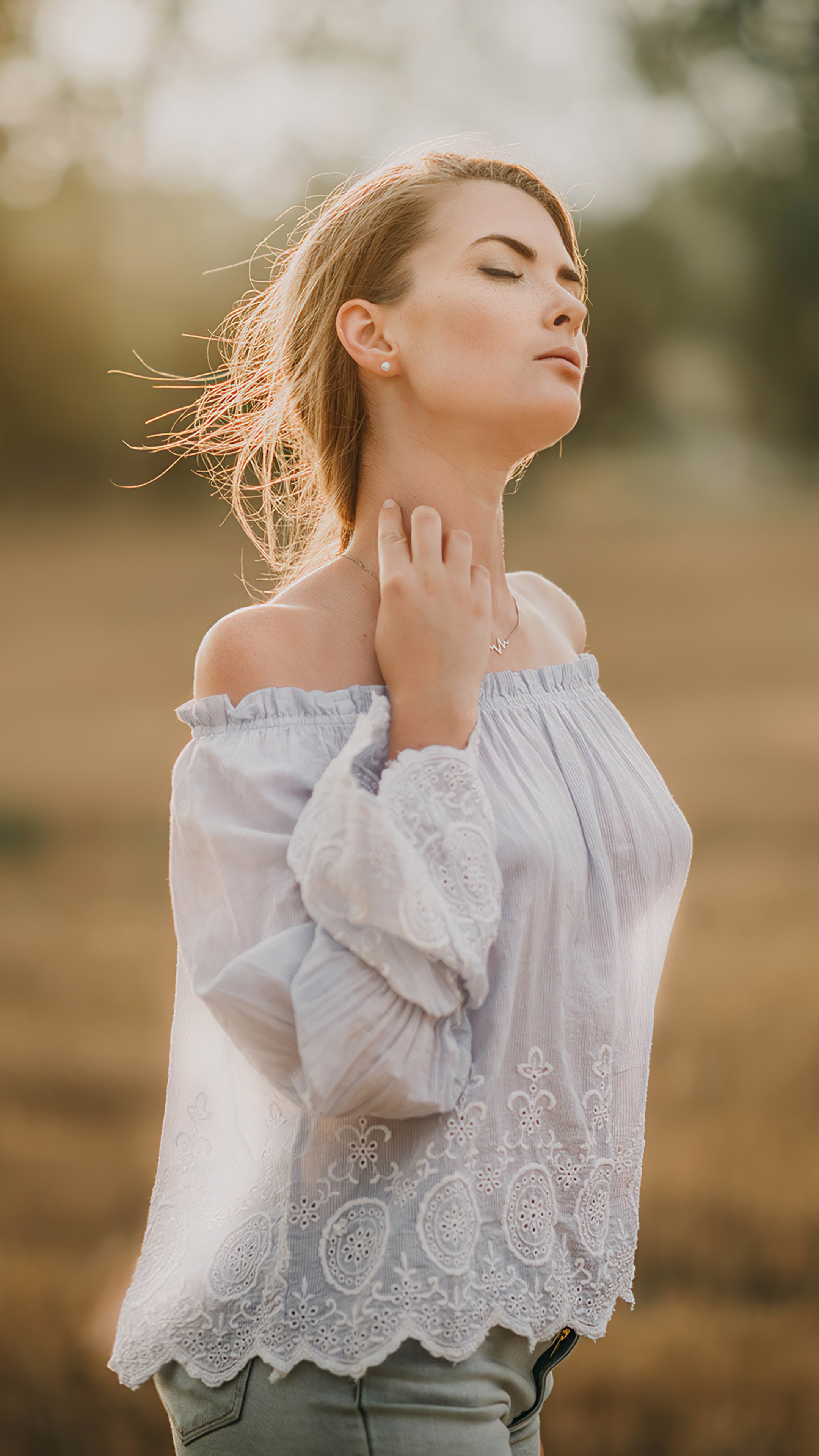 Woman with eyes closed in a field HD Phone Wallpaper