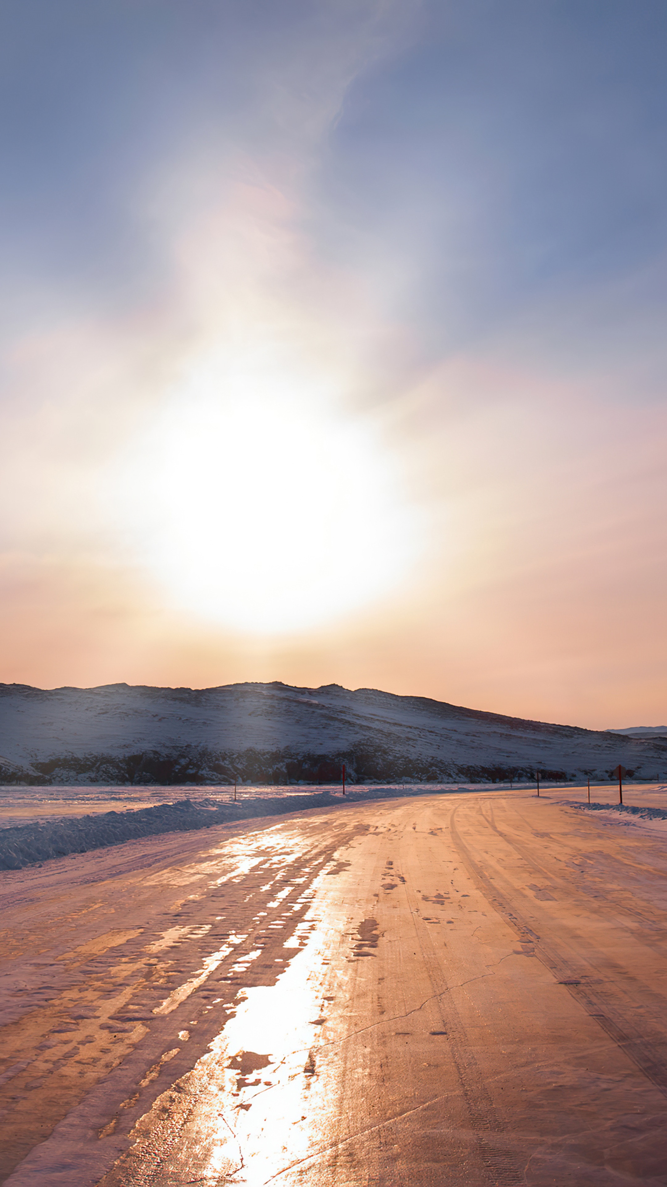 Snowy road with mountains and sun HD Phone Wallpaper