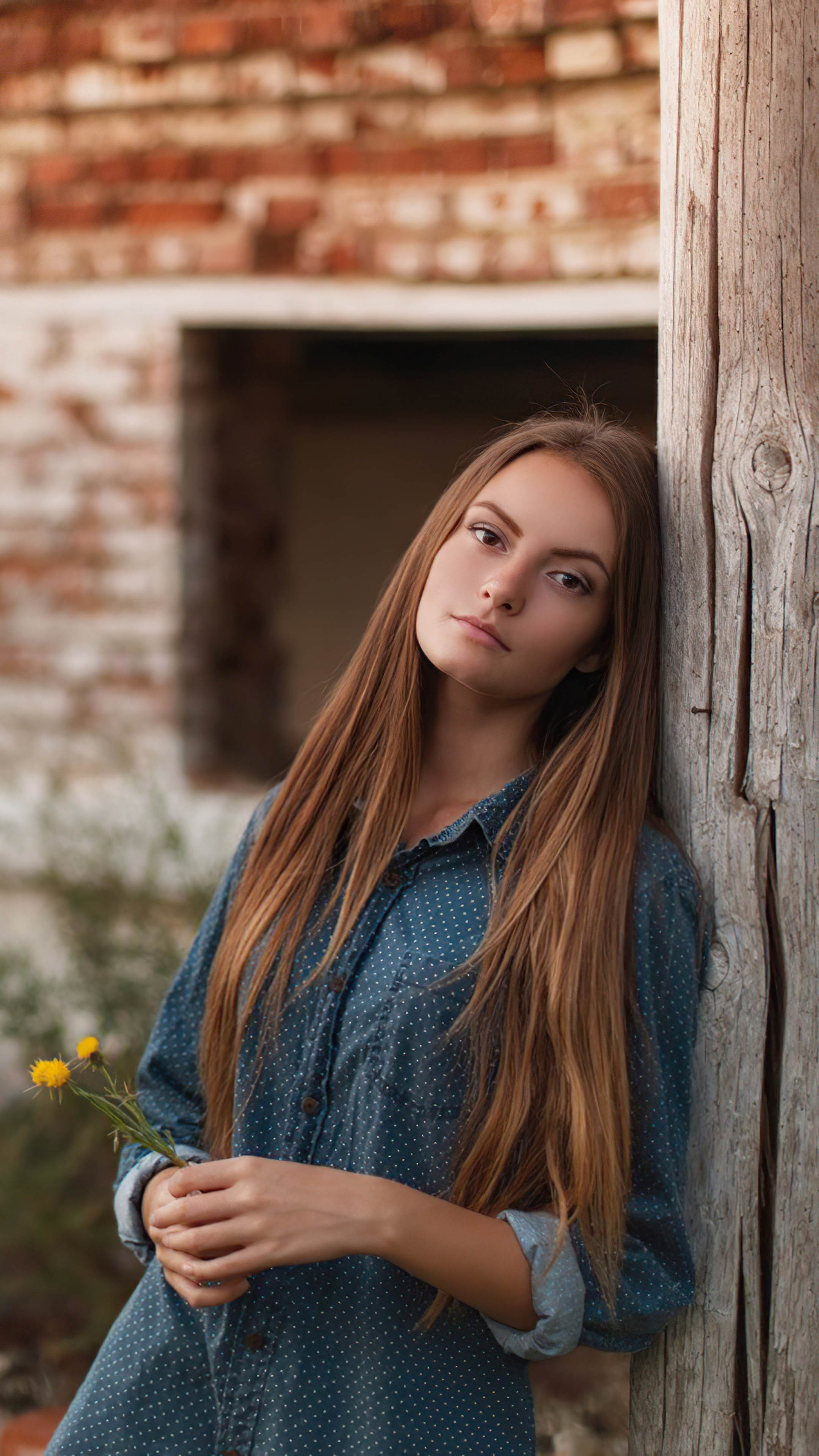 Young woman with long blonde hair holding yellow flowers HD Phone Wallpaper