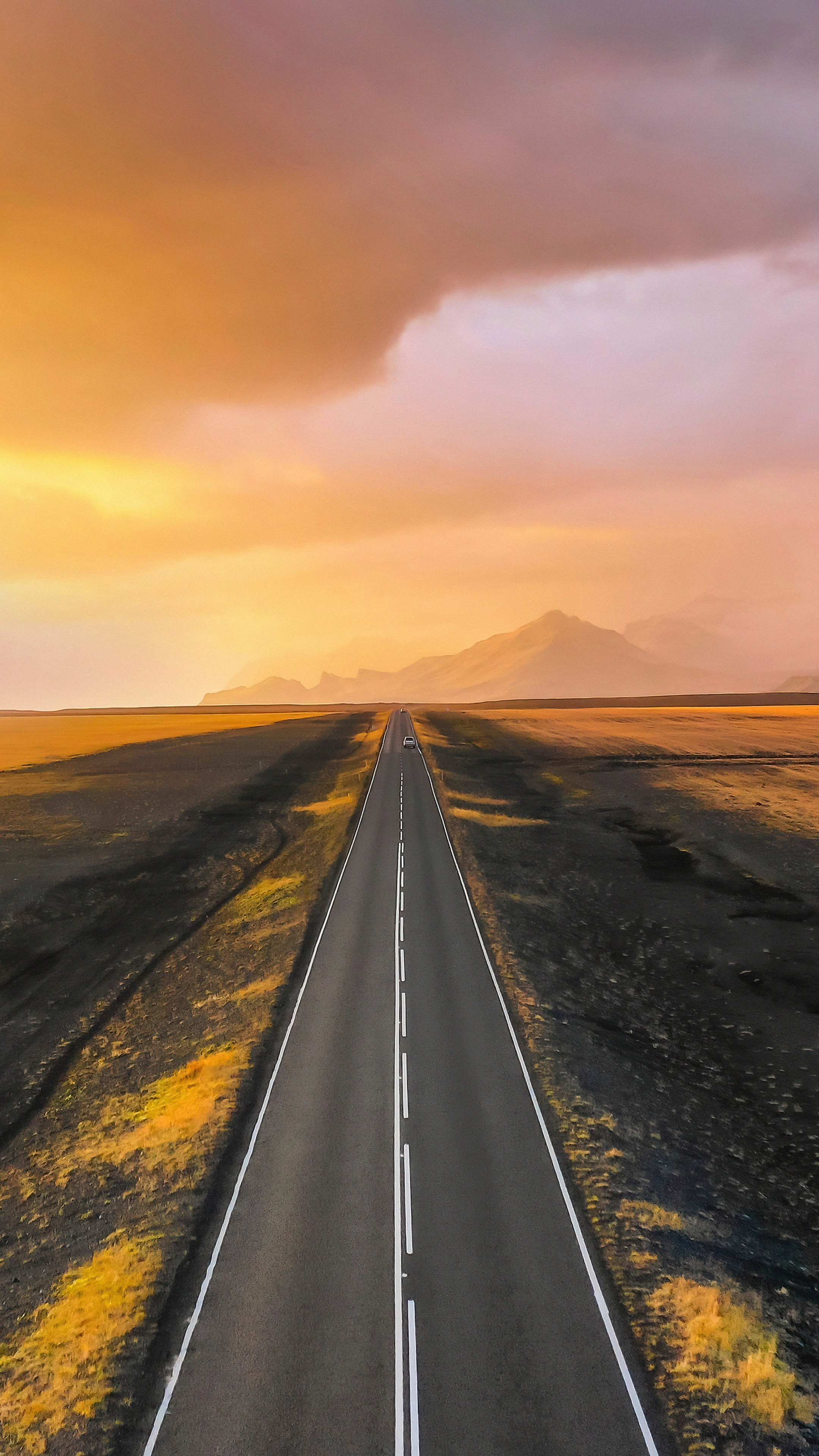 Road through a barren landscape at sunset HD Phone Wallpaper