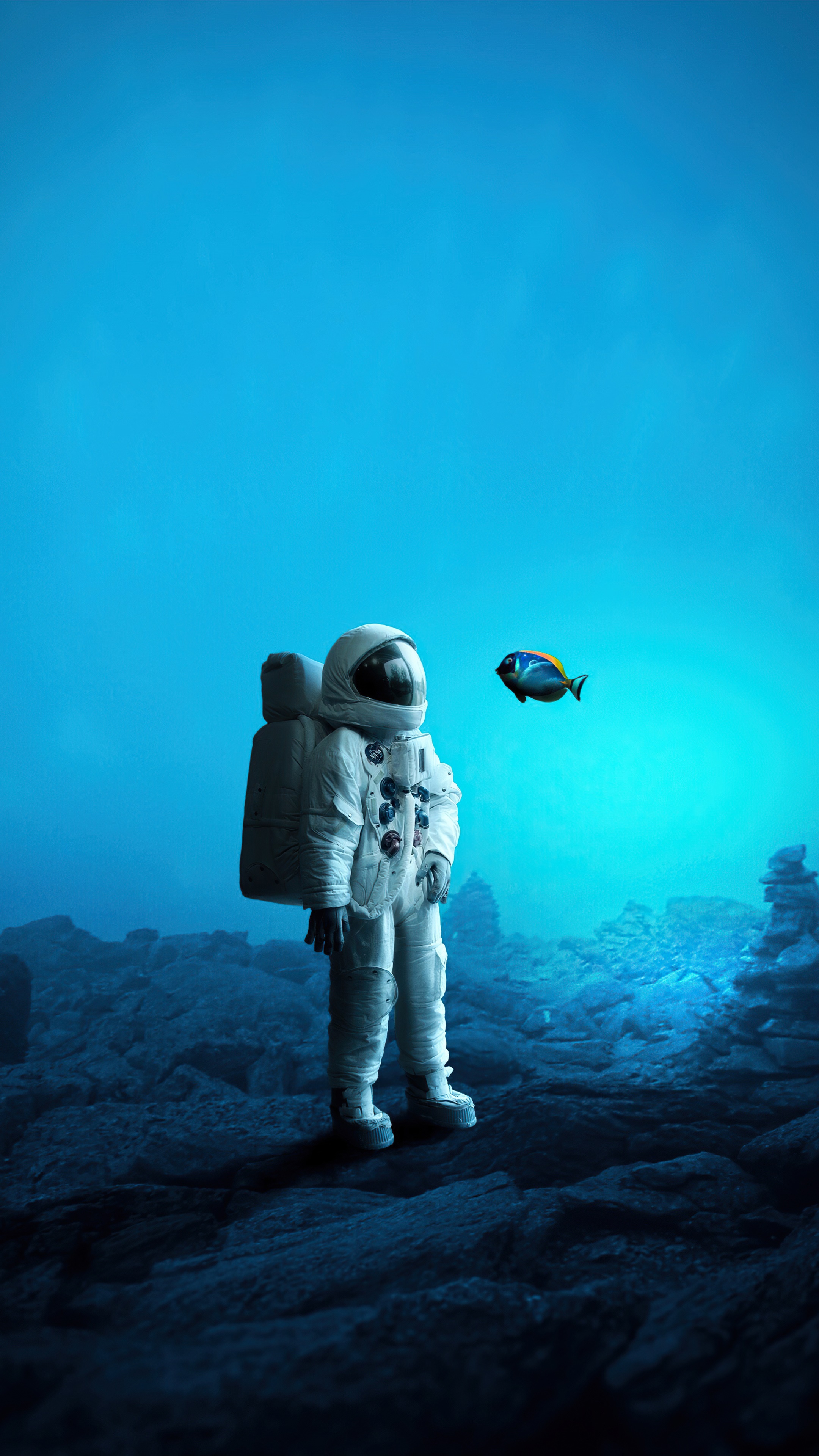 Astronaut in a blue ocean with a fish HD Phone Wallpaper