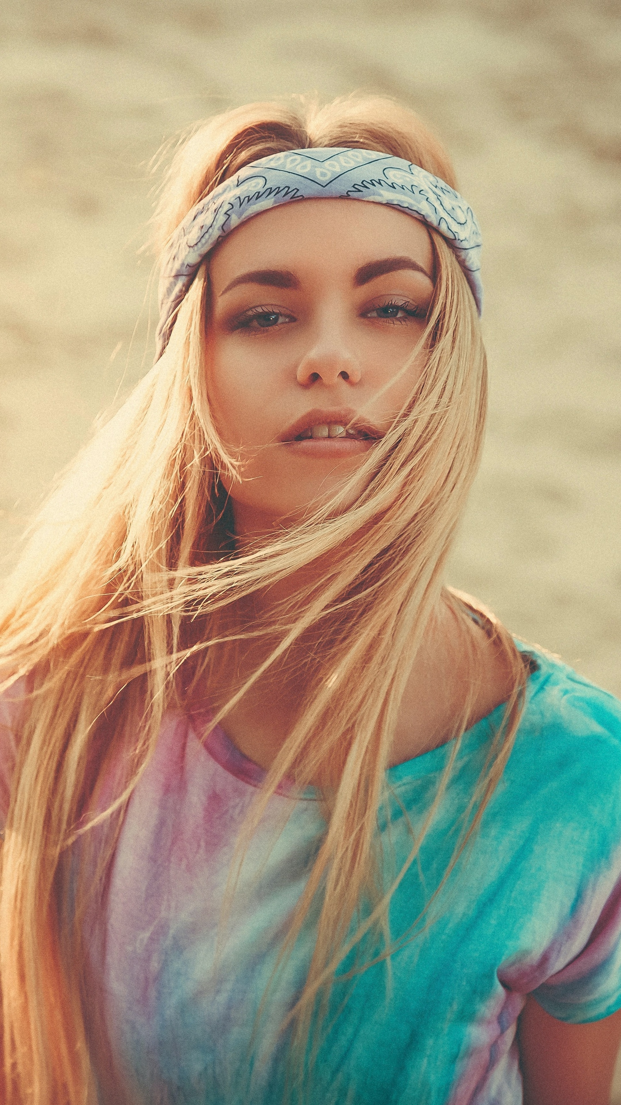 Woman with blonde hair wearing a bandana and tie-dye shirt HD Phone Wallpaper