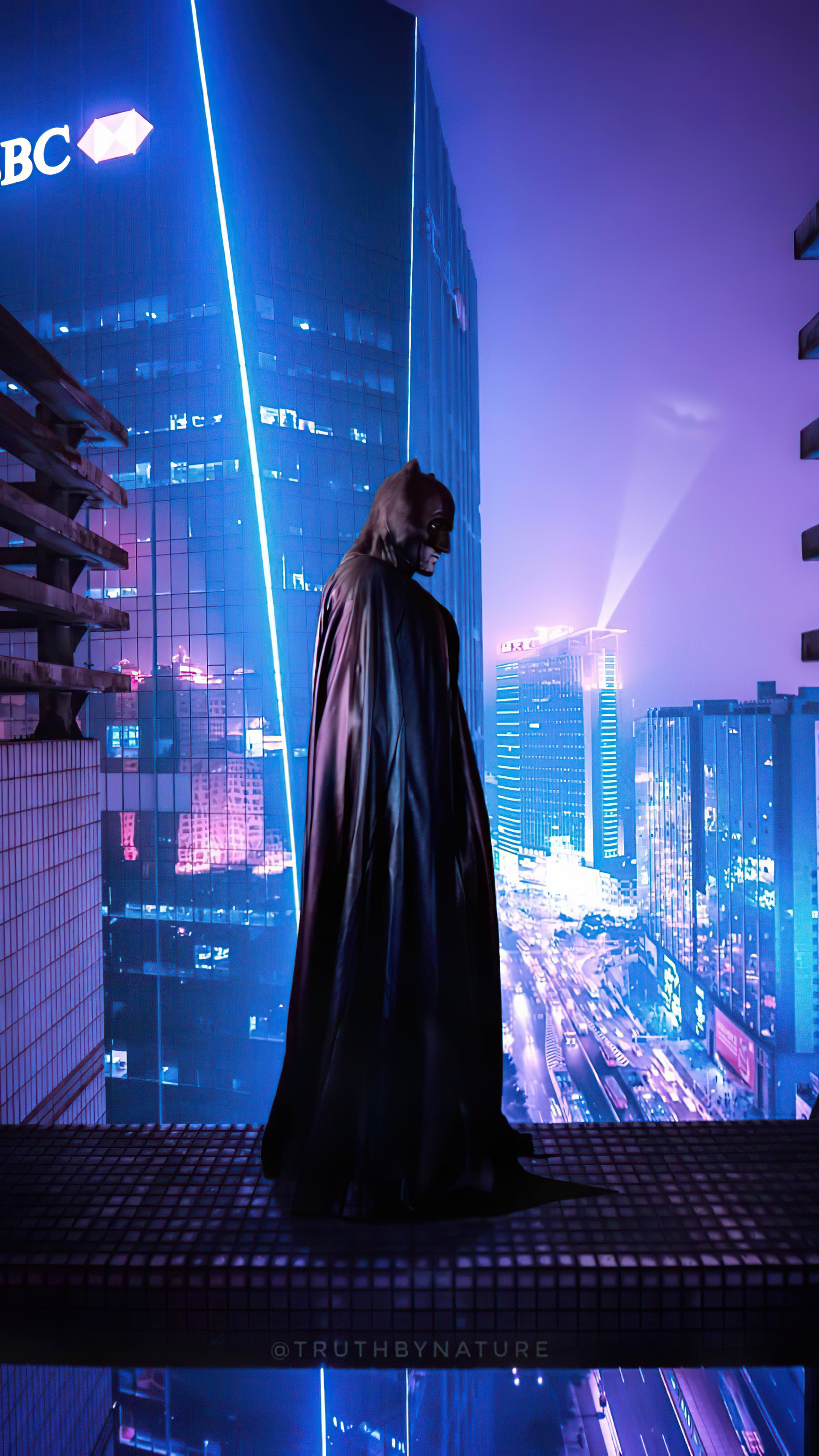 Batman in a neon city at night HD Phone Wallpaper