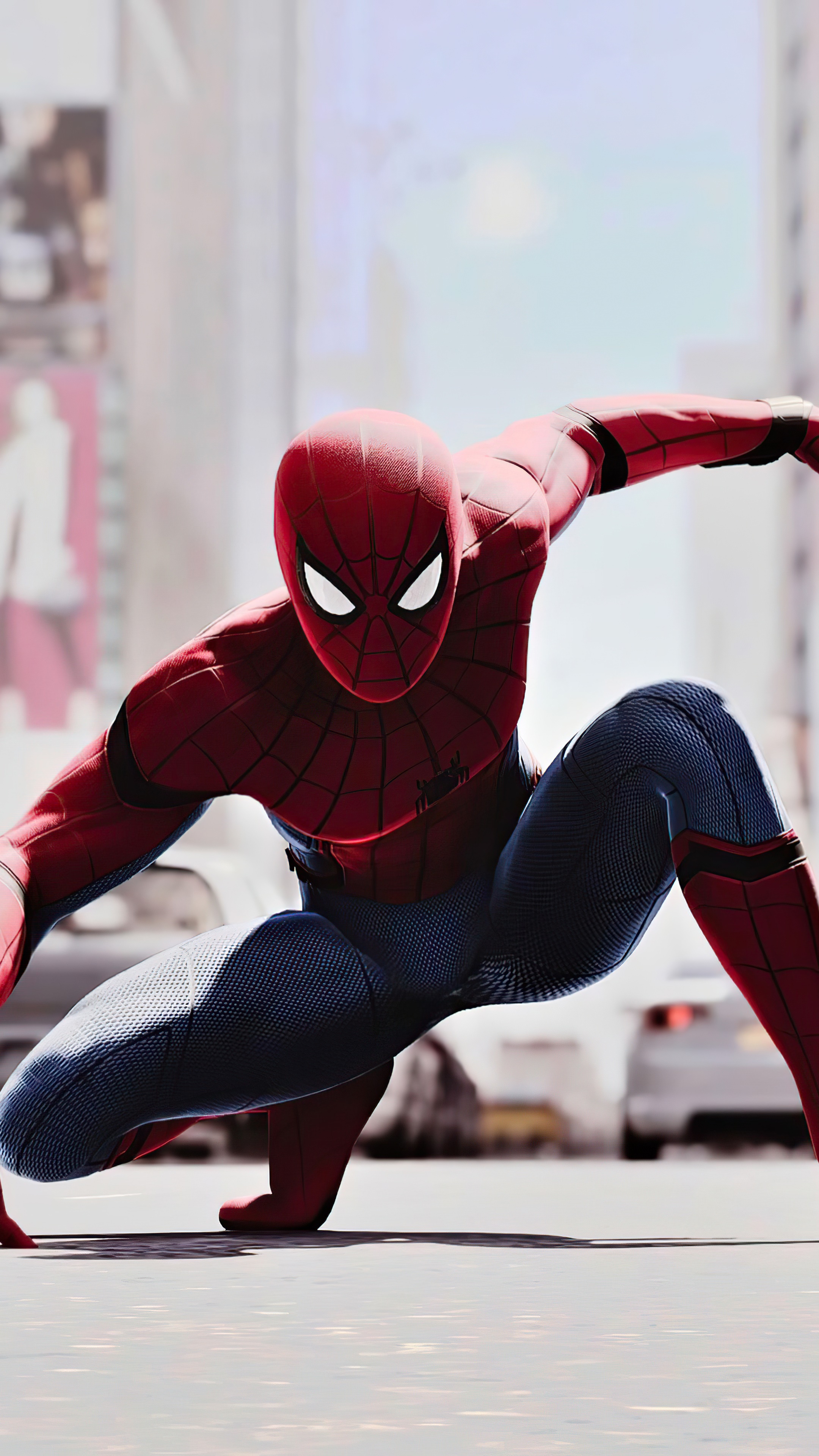 Spider-Man in a crouched pose on a city street HD Phone Wallpaper