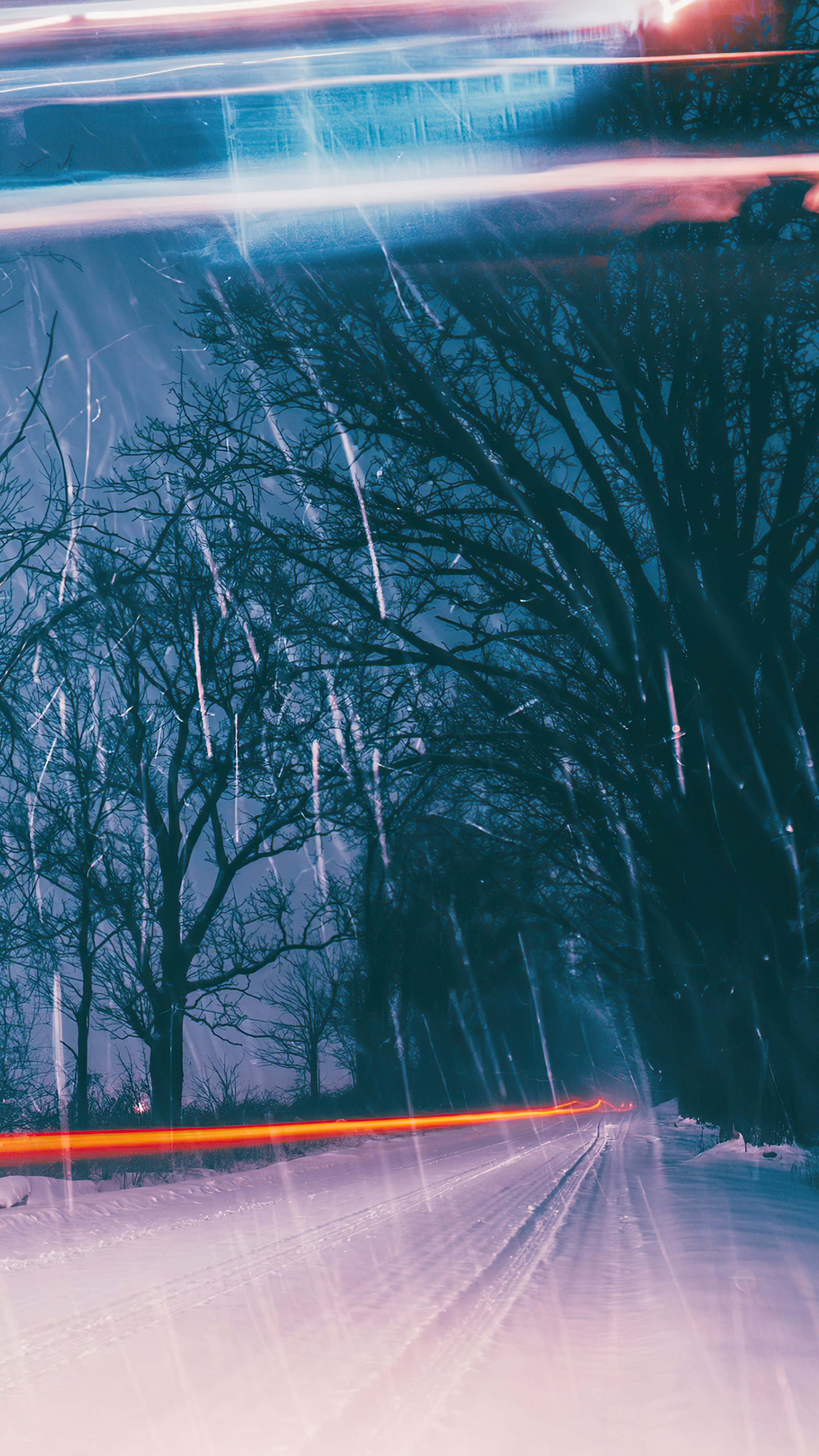Snow storm with light trails and trees HD Phone Wallpaper