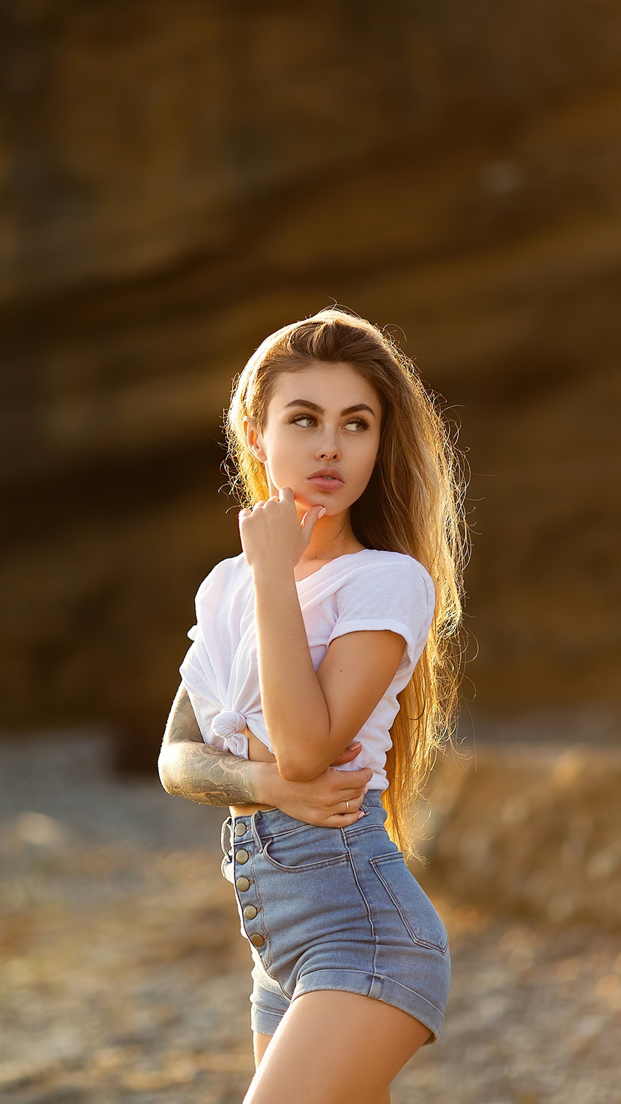 Model in white t-shirt and denim shorts HD Phone Wallpaper