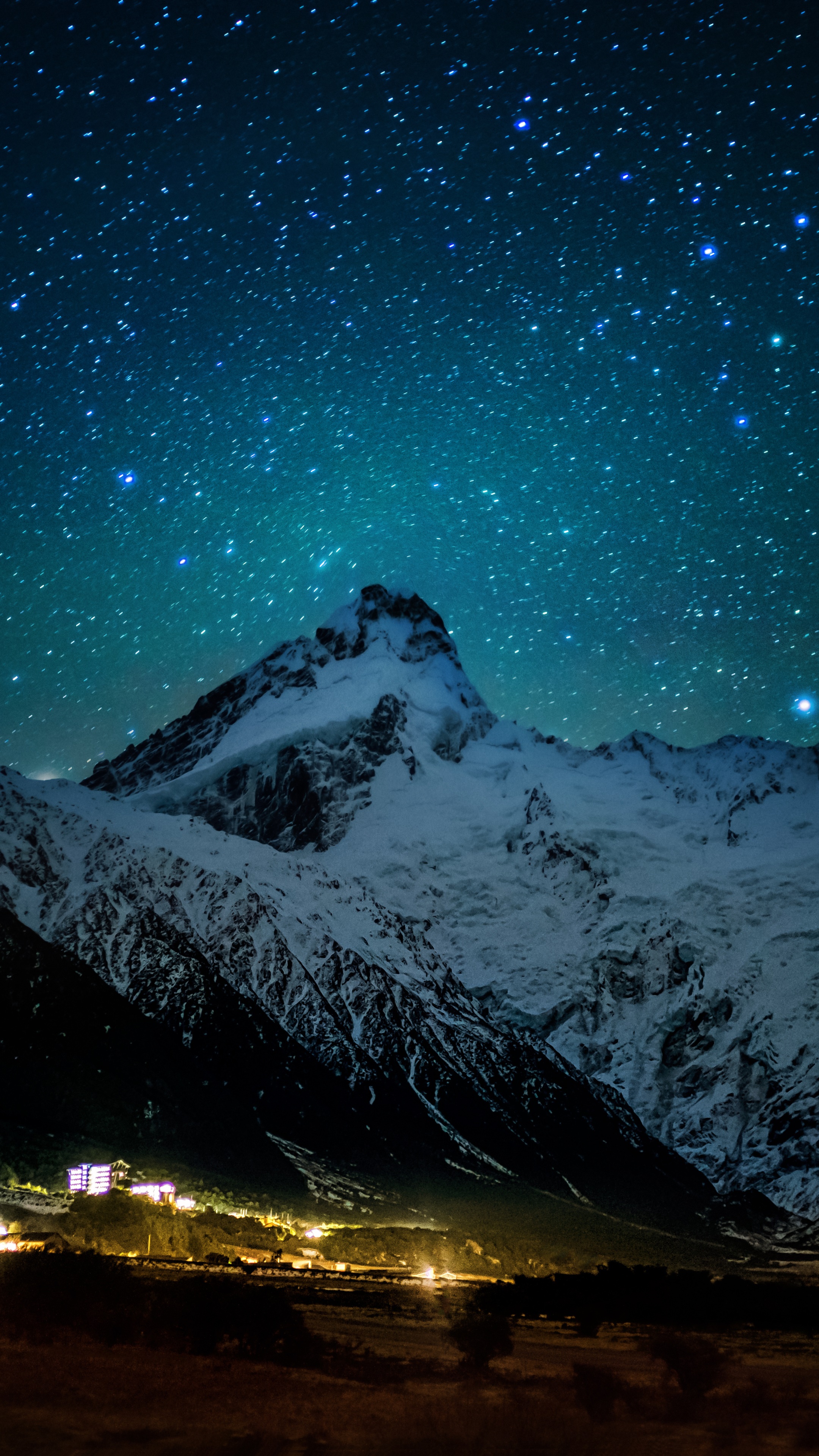 Snowy mountains under a starry night sky HD Phone Wallpaper