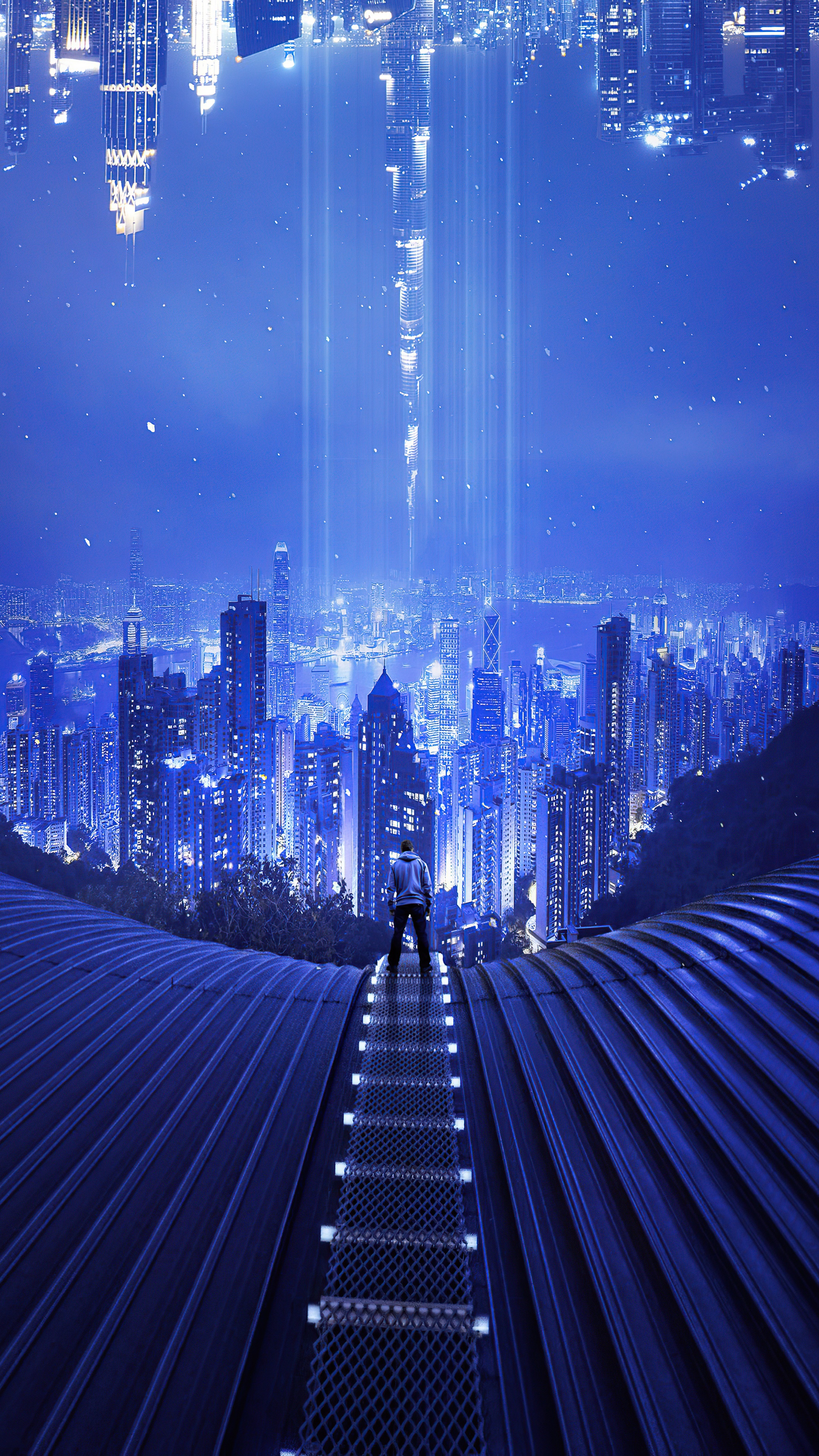 Man in hoodie on walkway overlooking city at night HD Phone Wallpaper