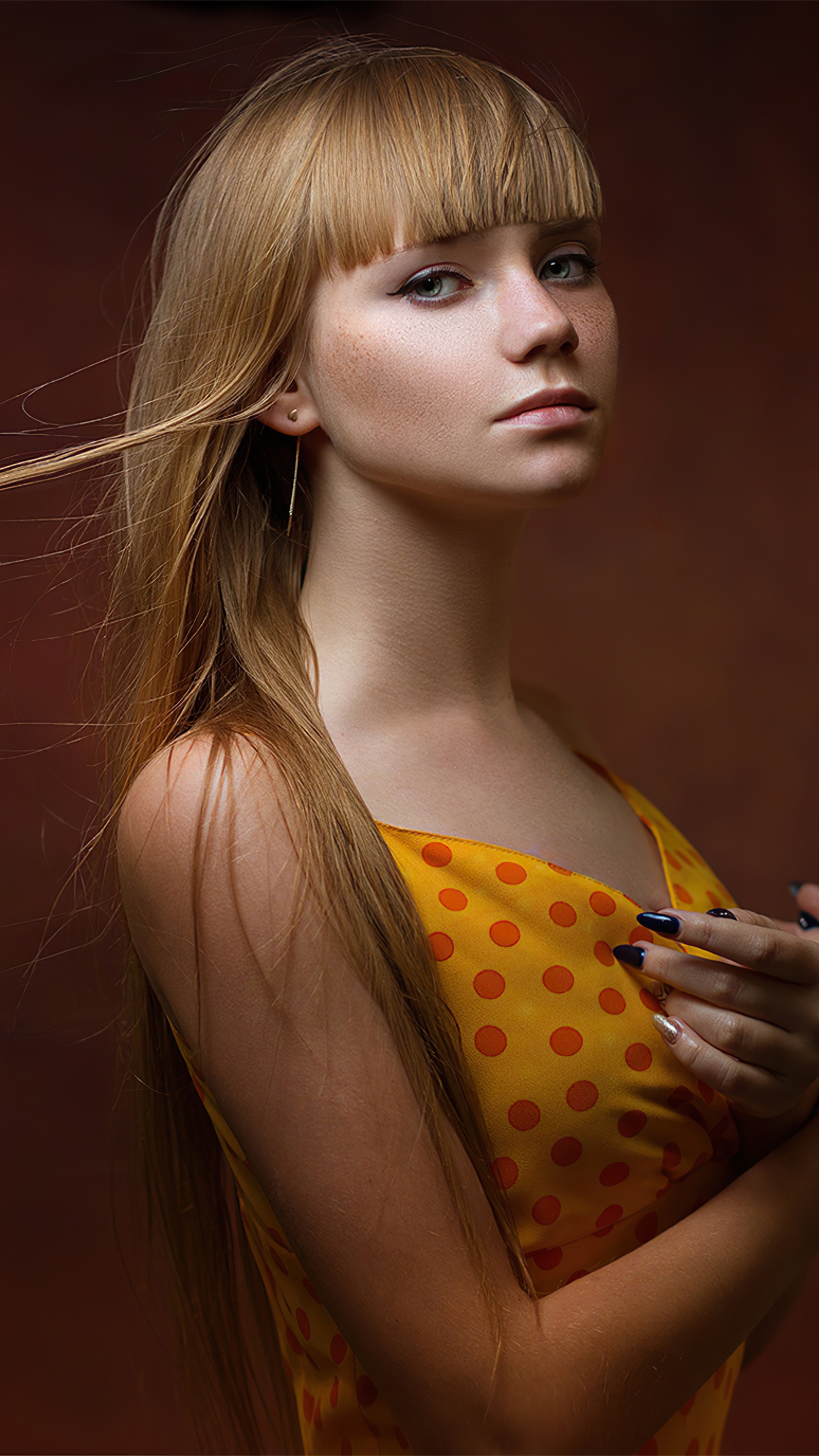 Blonde girl with bangs and freckles in yellow polka dot dress HD Phone Wallpaper