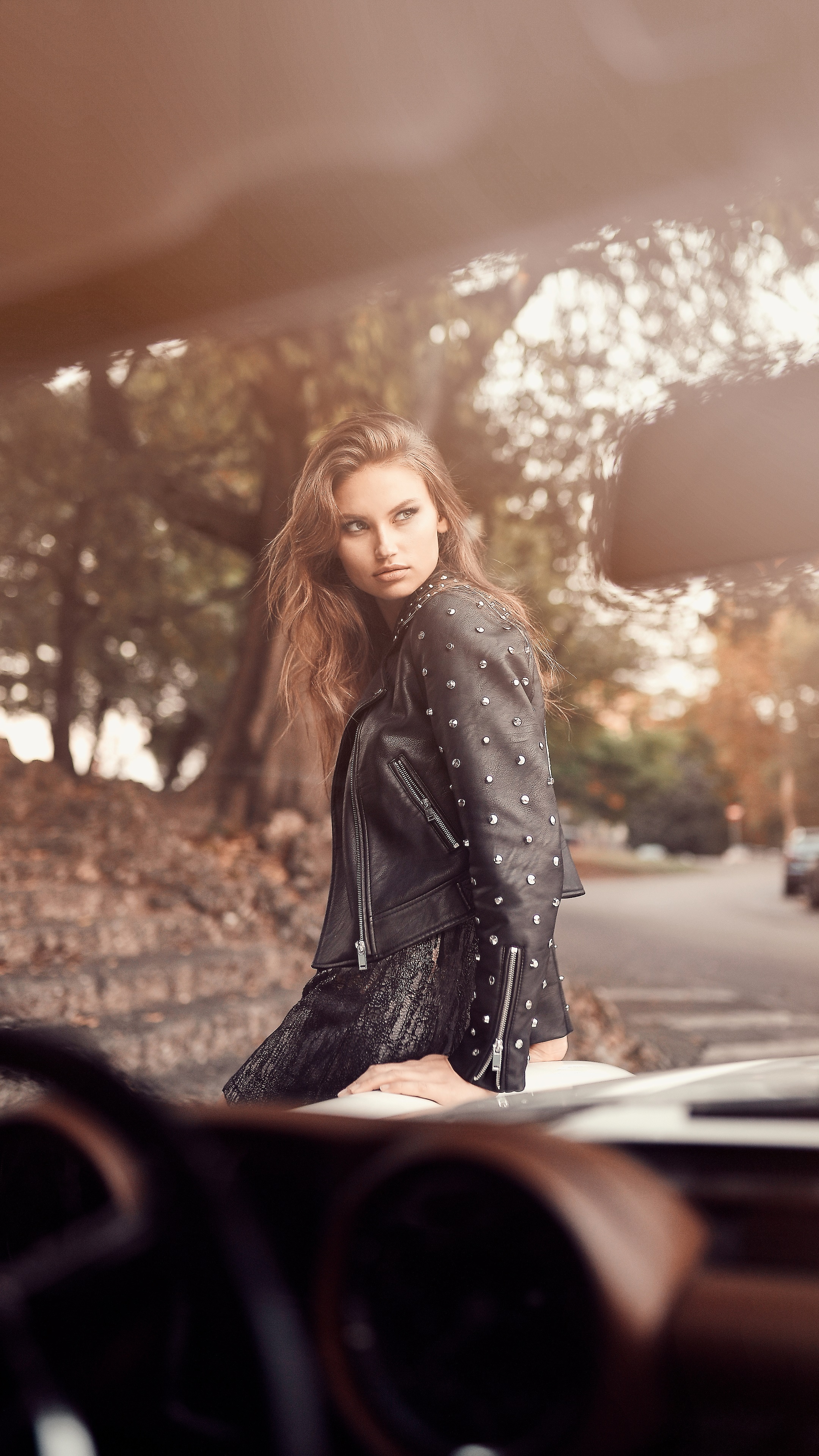 Model in studded leather jacket by a car HD Phone Wallpaper
