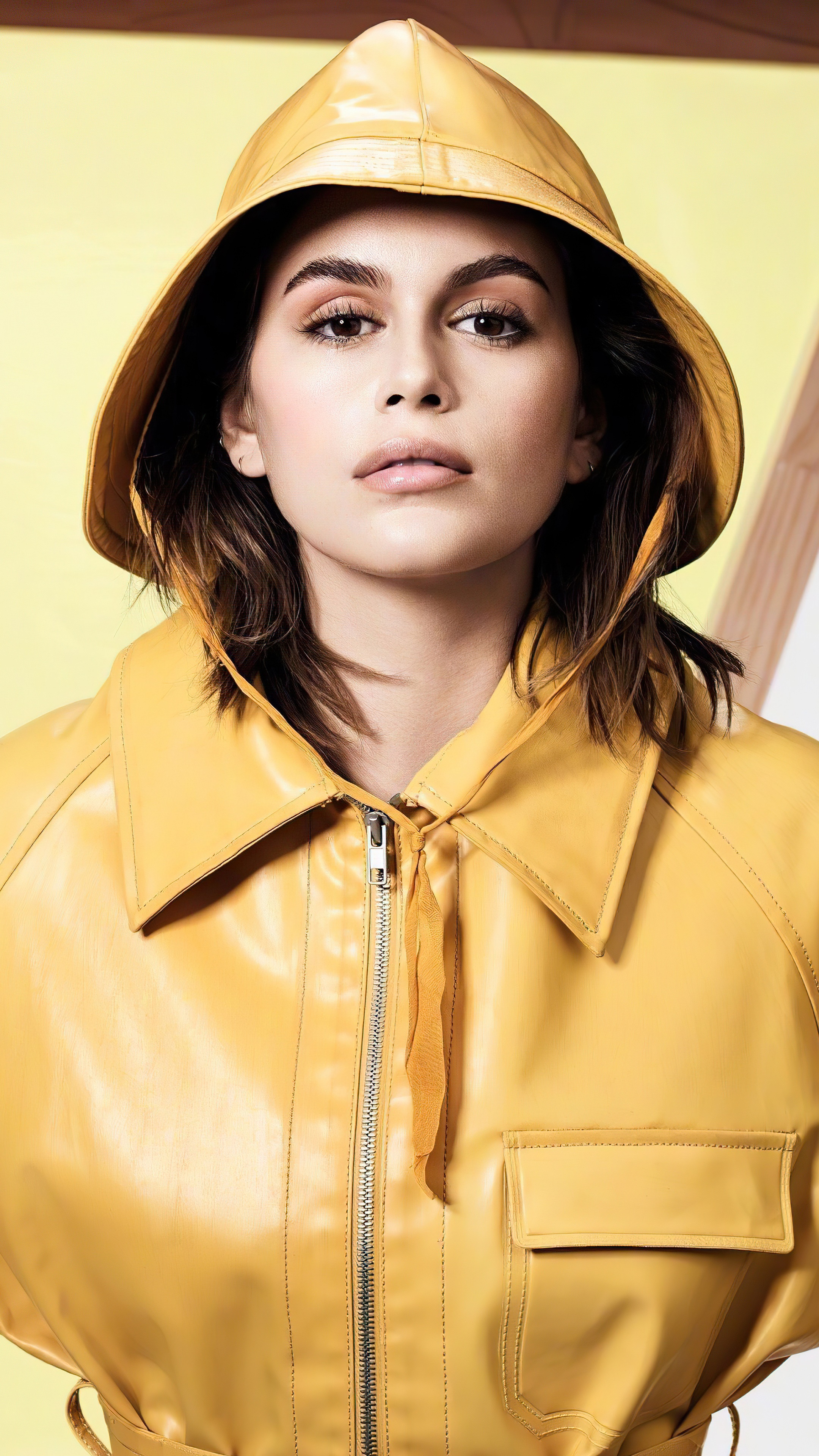 Kaia Gerber in yellow raincoat and hat HD Phone Wallpaper