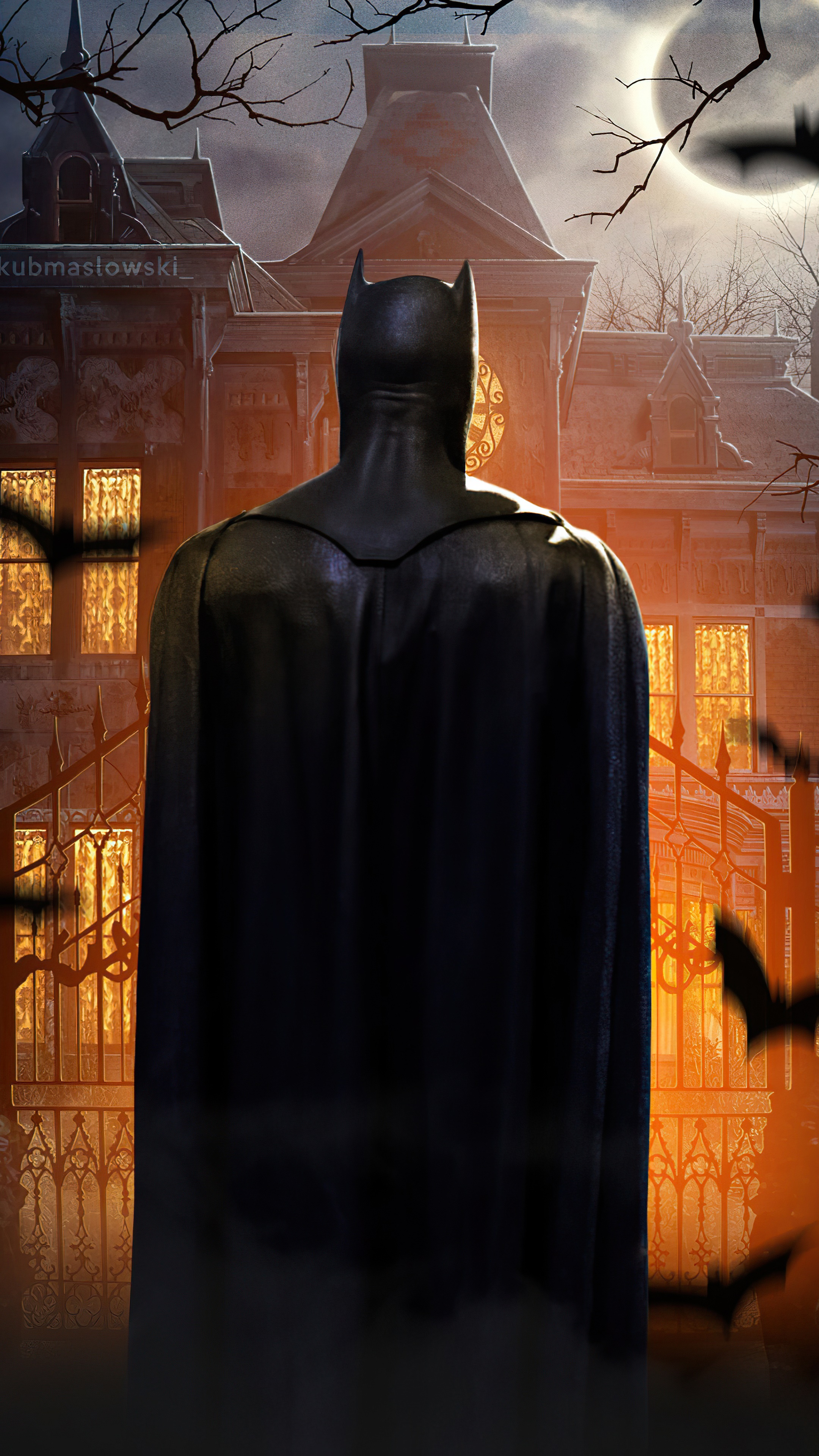Batman in front of a haunted mansion HD Phone Wallpaper