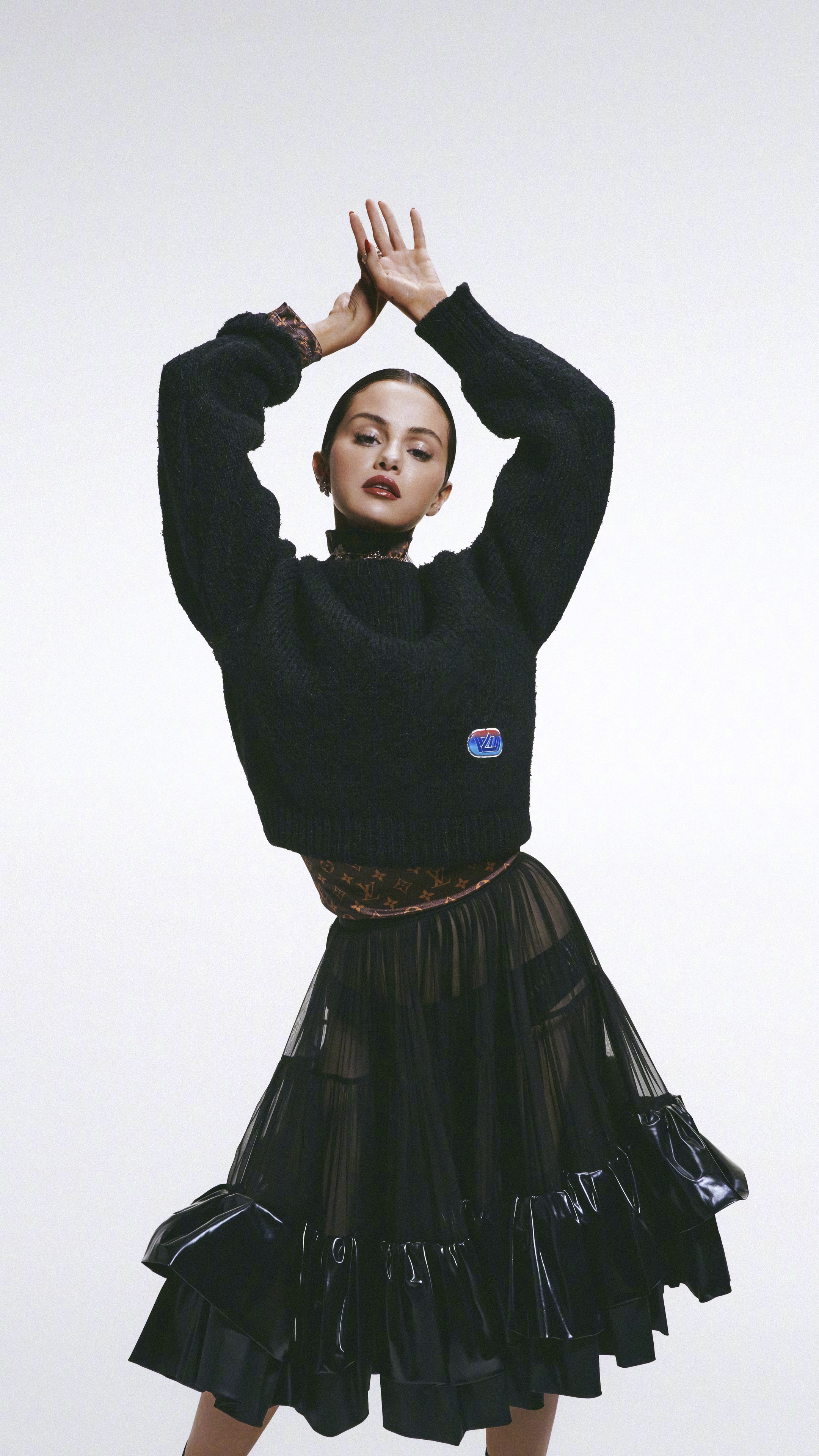 Selena Gomez in black sweater and skirt HD Phone Wallpaper