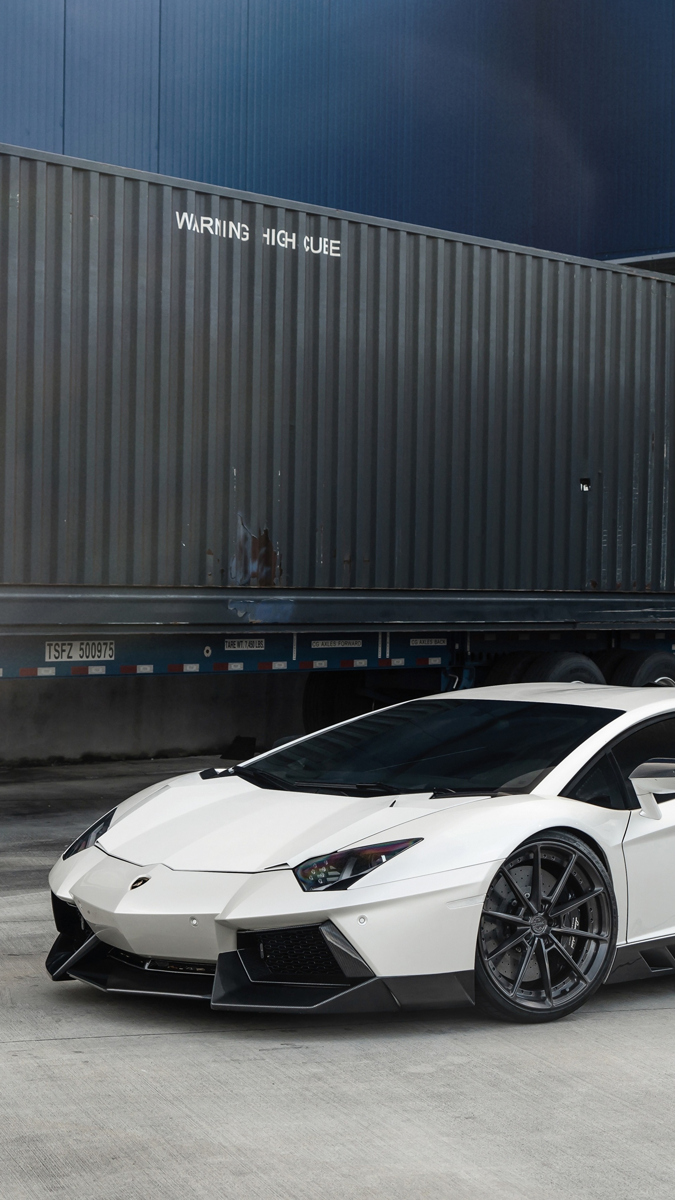 White Lamborghini Aventador parked near a shipping container HD Phone Wallpaper