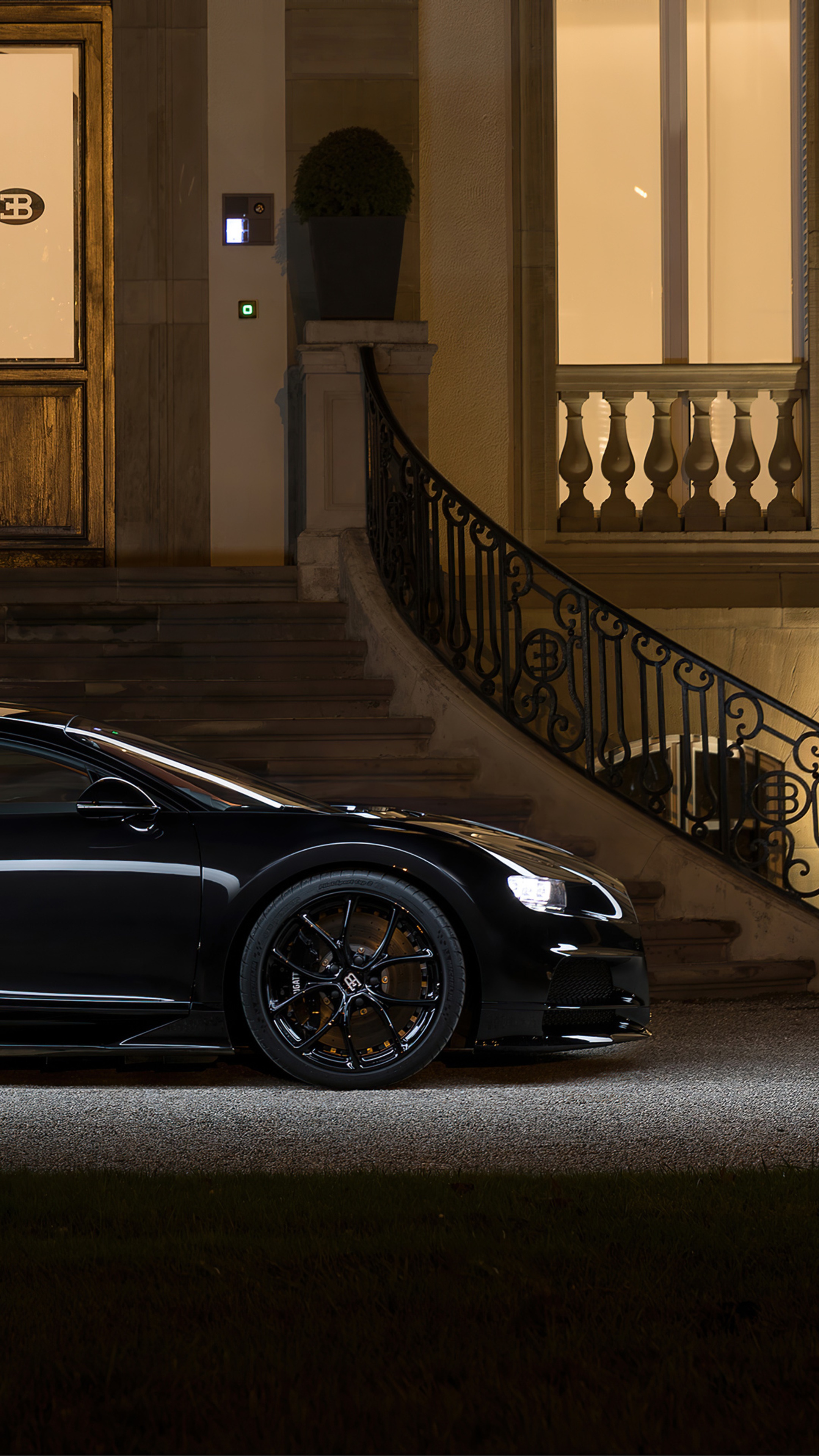 Black Bugatti Chiron parked in front of a building at night HD Phone Wallpaper