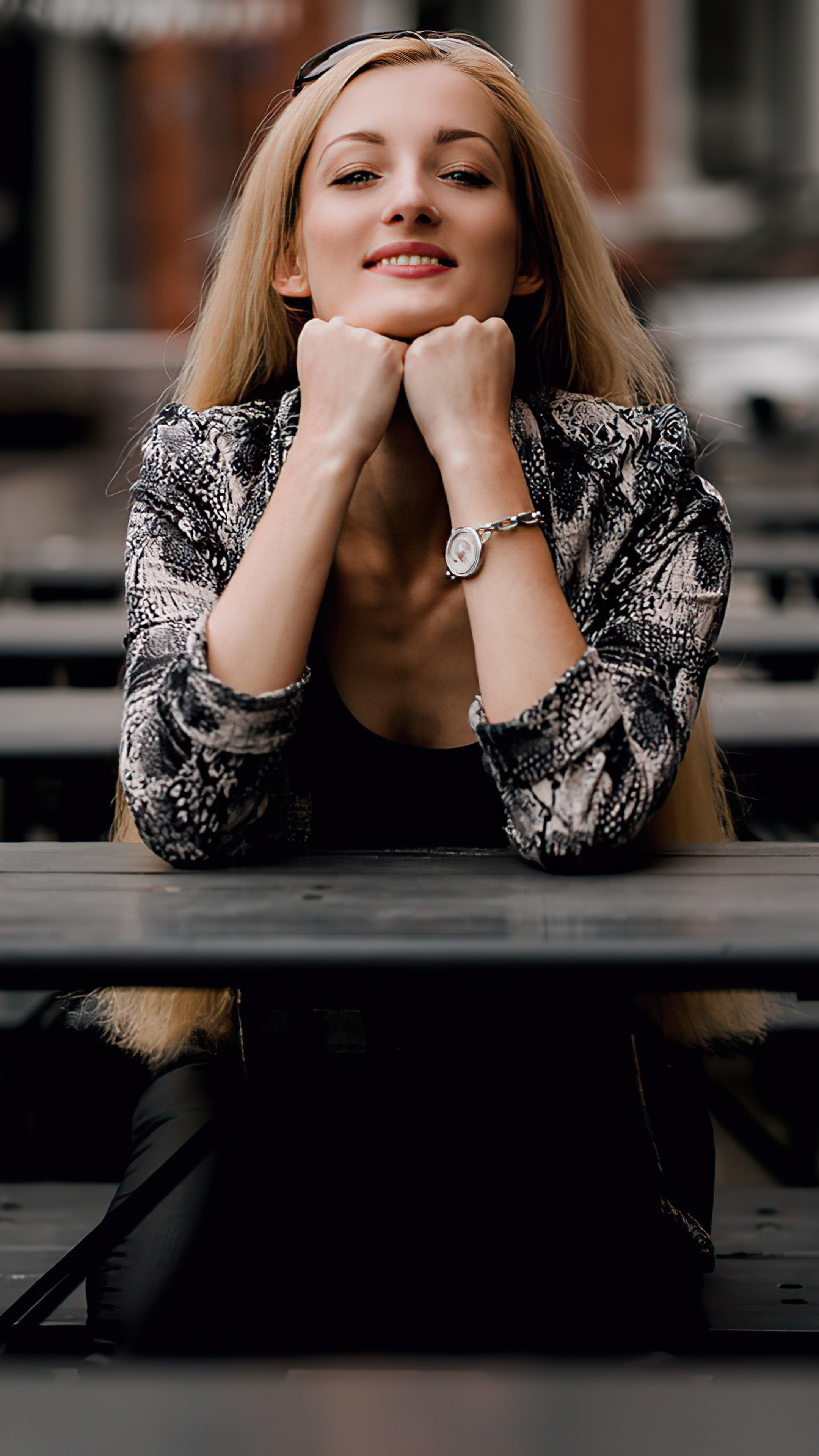 Woman with blonde hair wearing a patterned jacket HD Phone Wallpaper
