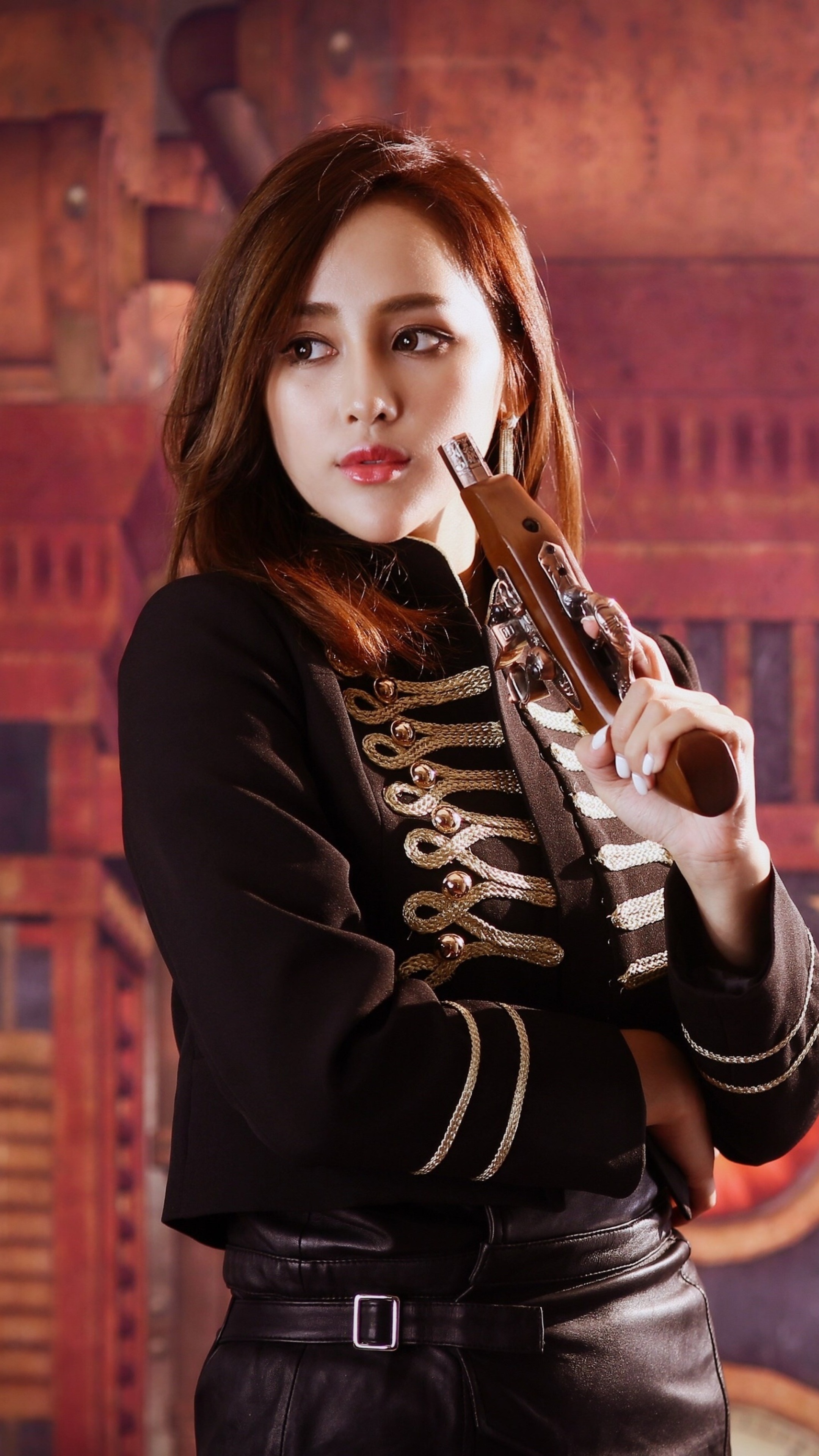 Woman in black military-style jacket holding a pistol HD Phone Wallpaper