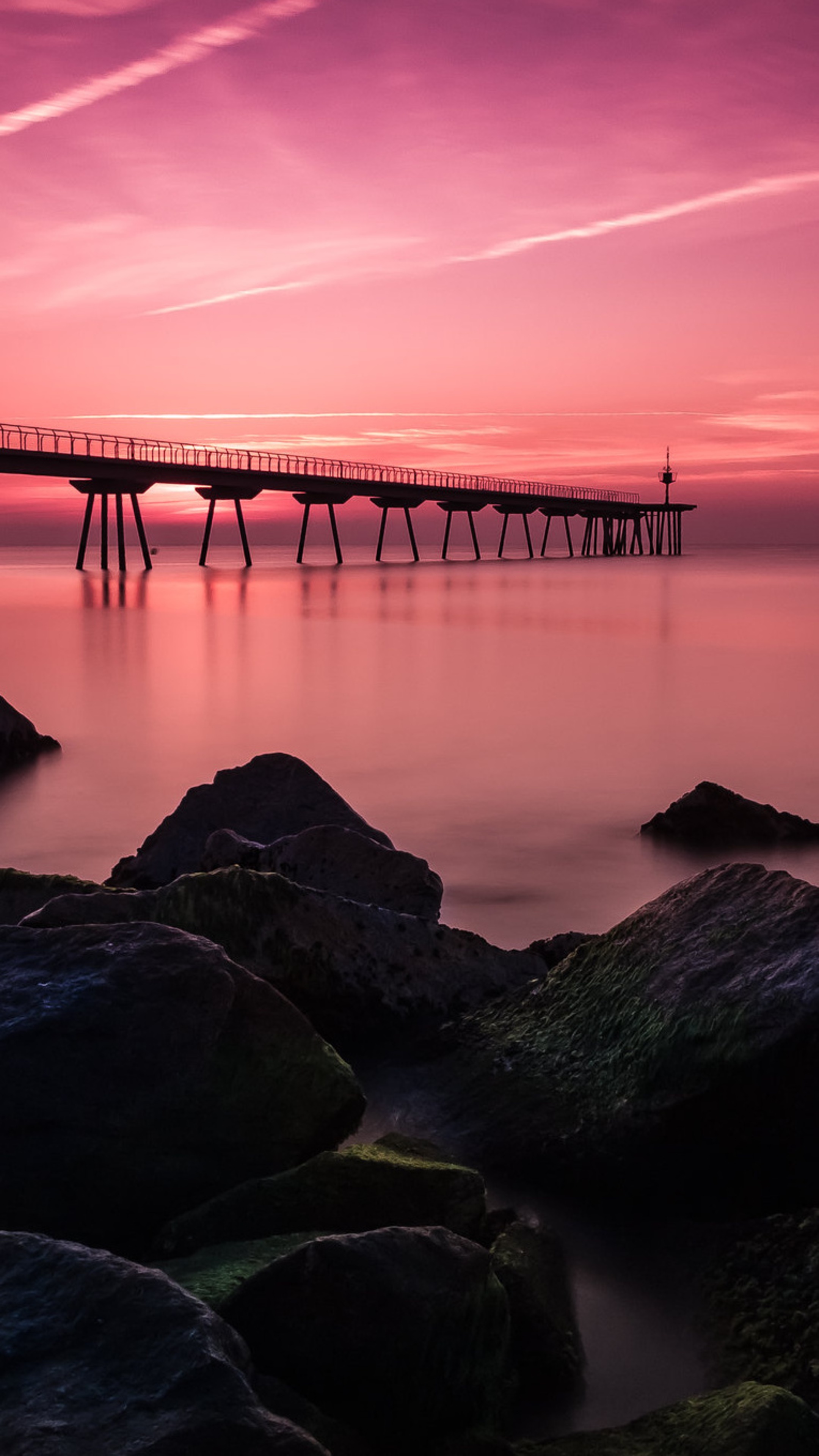 Long exposure of a bridge over water with rocks in the foreground HD Phone Wallpaper