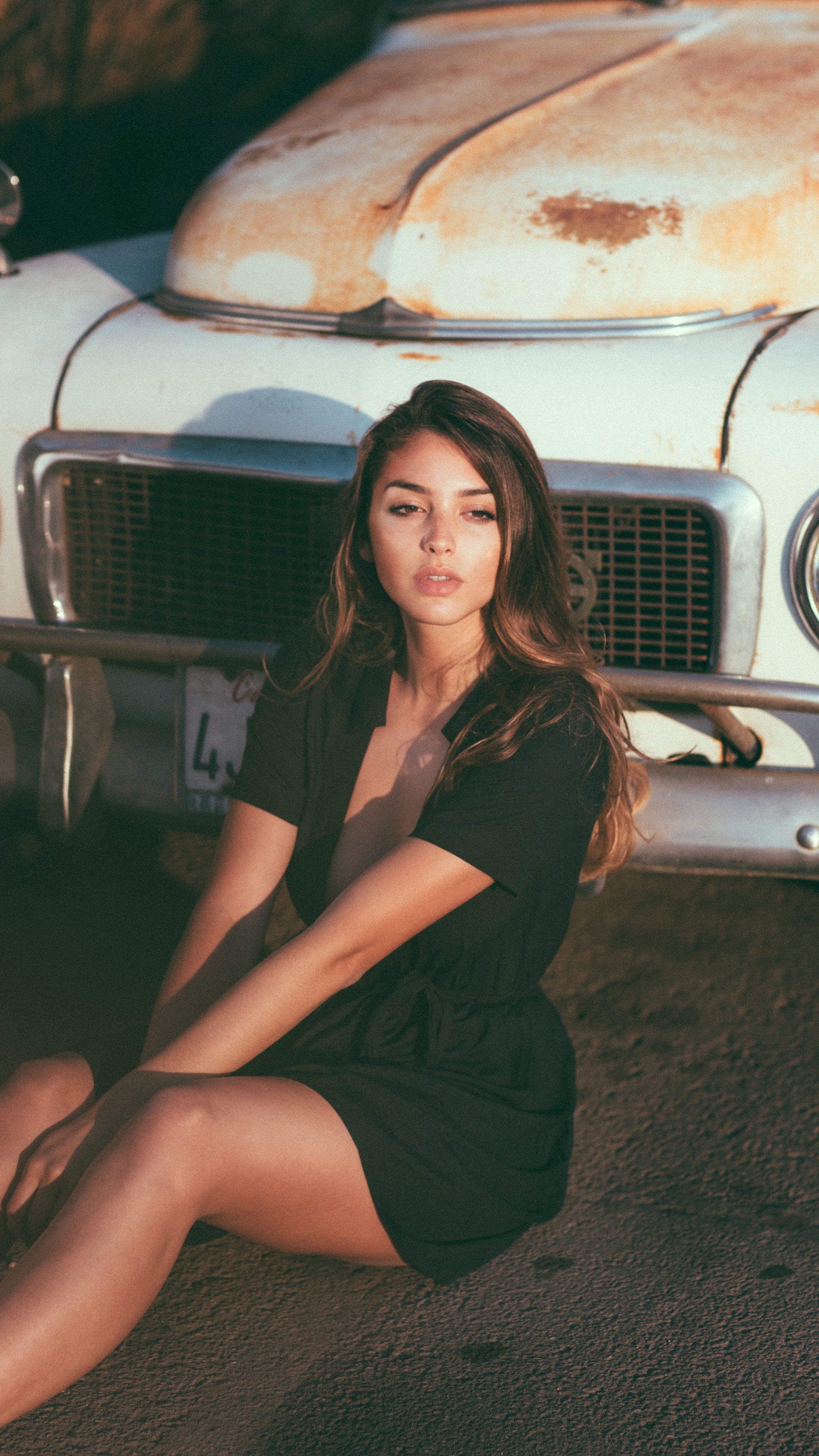 Celine Farach sitting in front of a vintage car HD Phone Wallpaper