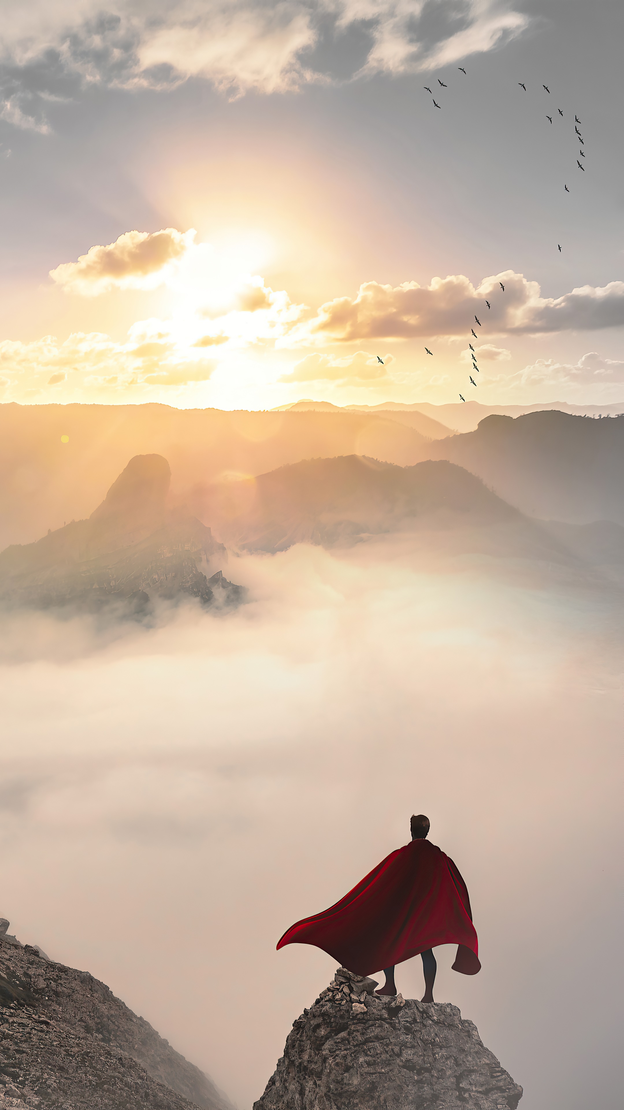 Superman standing on a mountain peak at sunrise HD Phone Wallpaper
