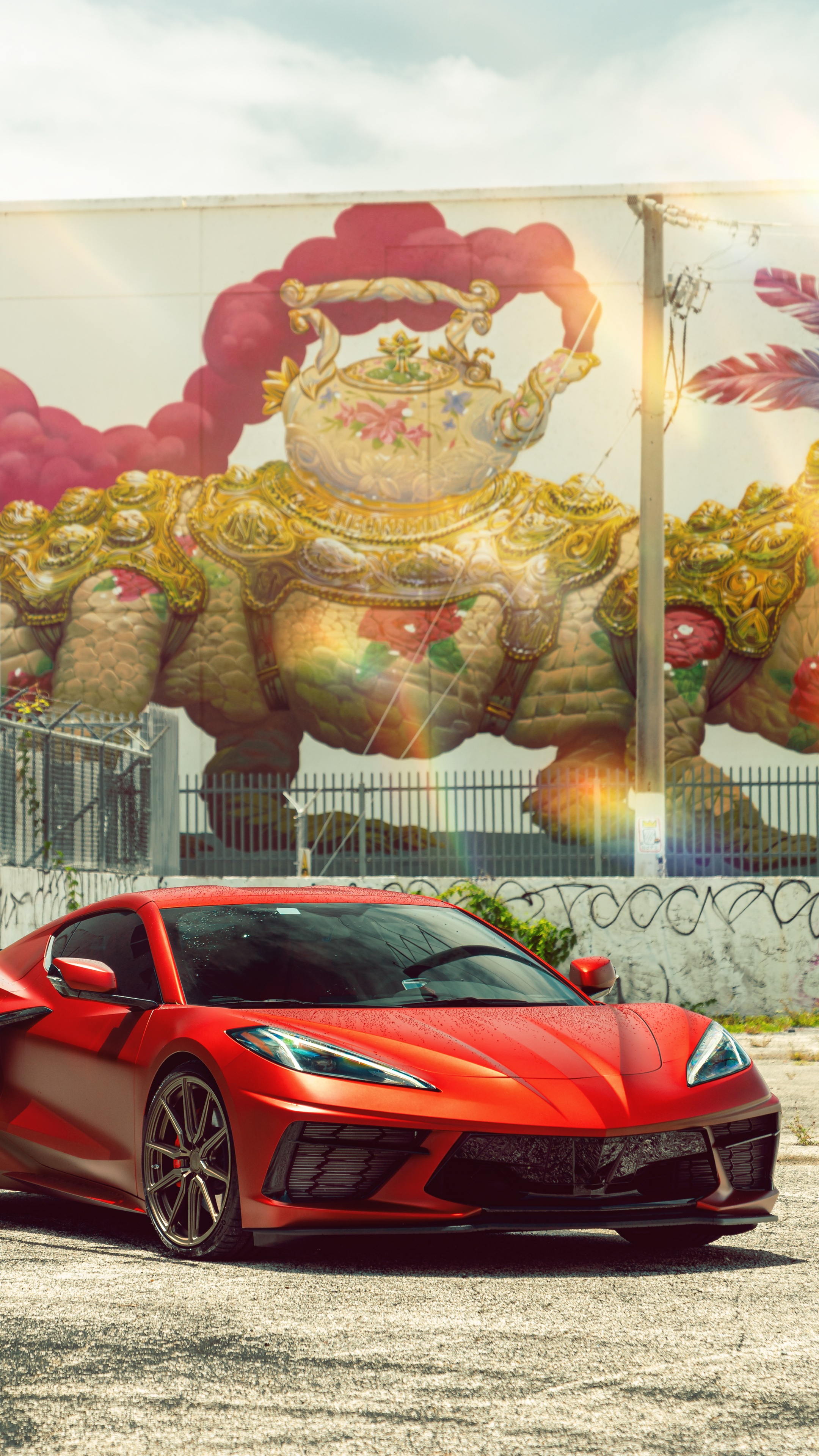 Red Chevrolet Corvette Stingray C8 in front of mural HD Phone Wallpaper