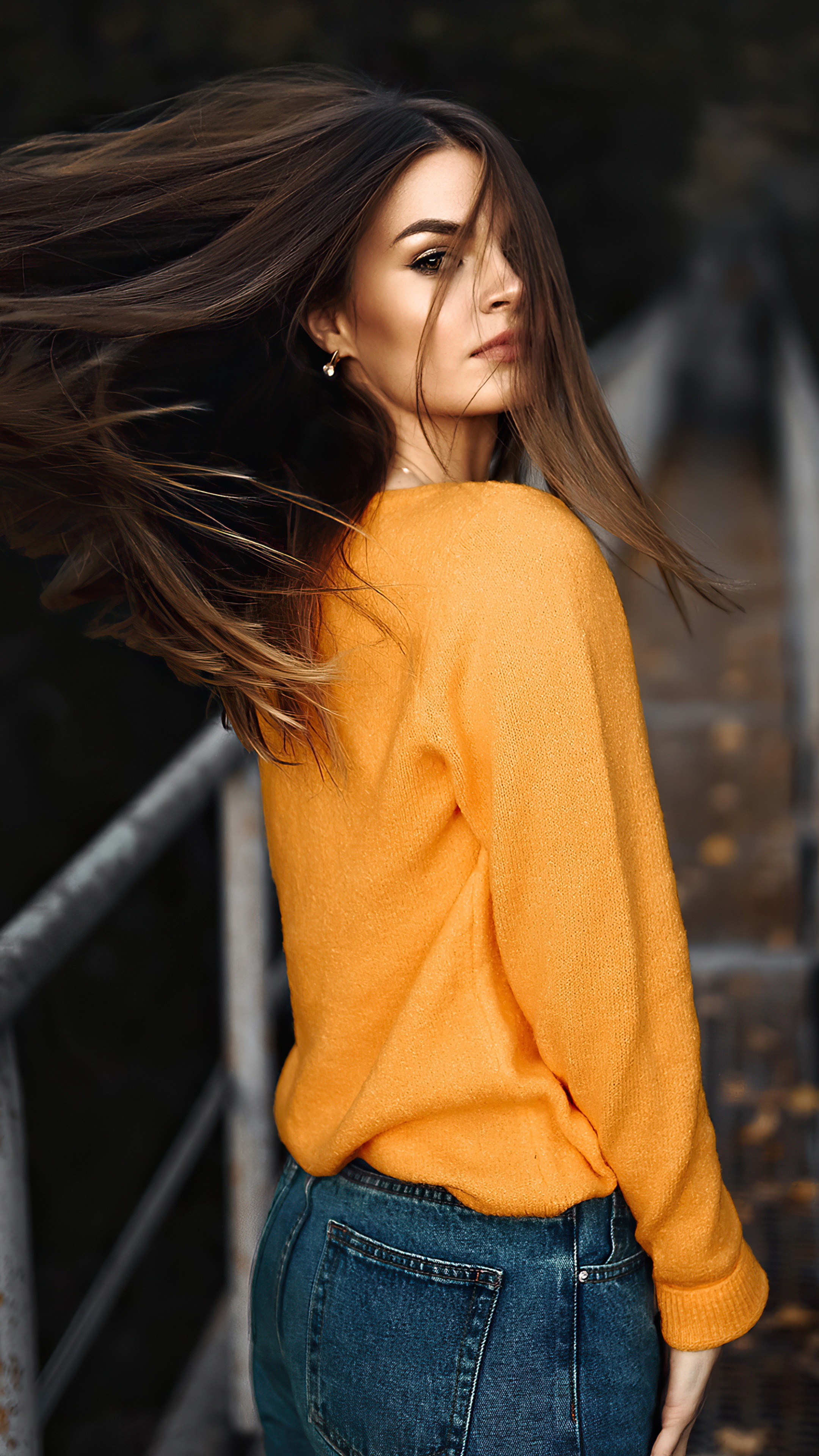 Model wearing orange sweater and jeans HD Phone Wallpaper