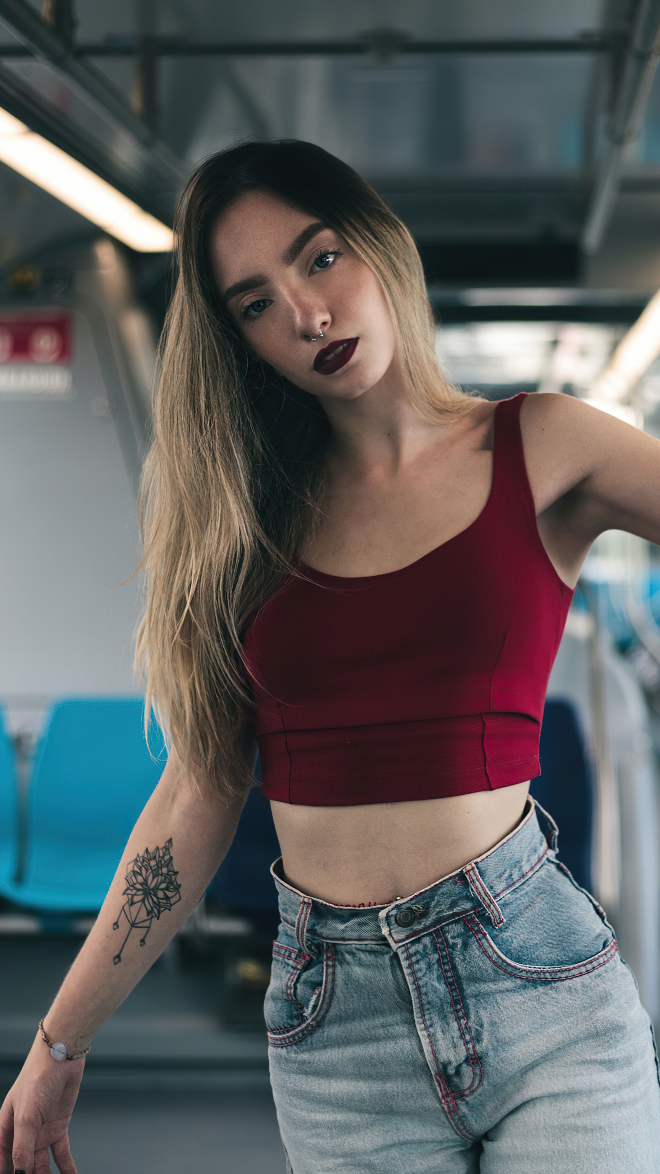 Woman in crop top and jeans on a train HD Phone Wallpaper