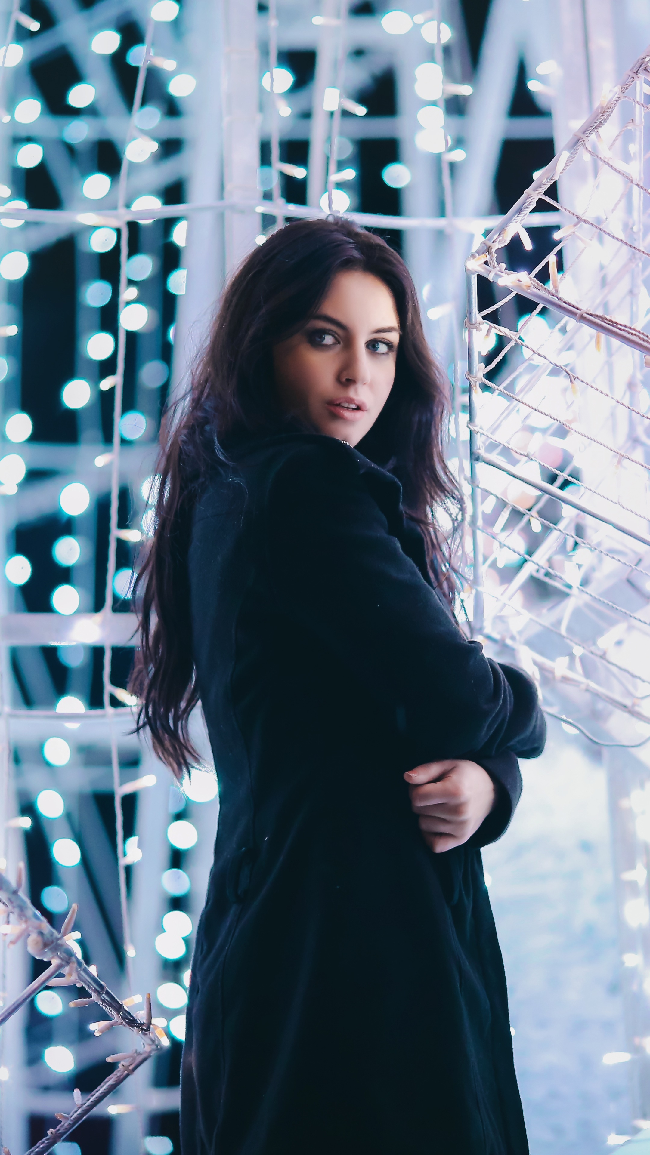 Model in black coat with blue lights HD Phone Wallpaper