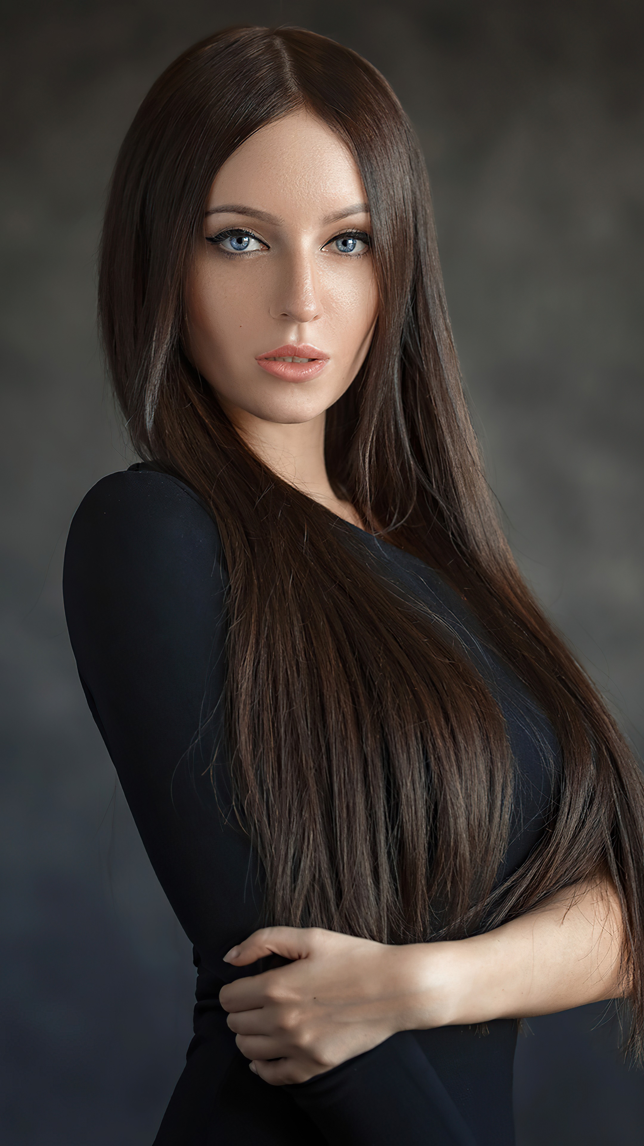 Woman with long brown hair in a black dress HD Phone Wallpaper