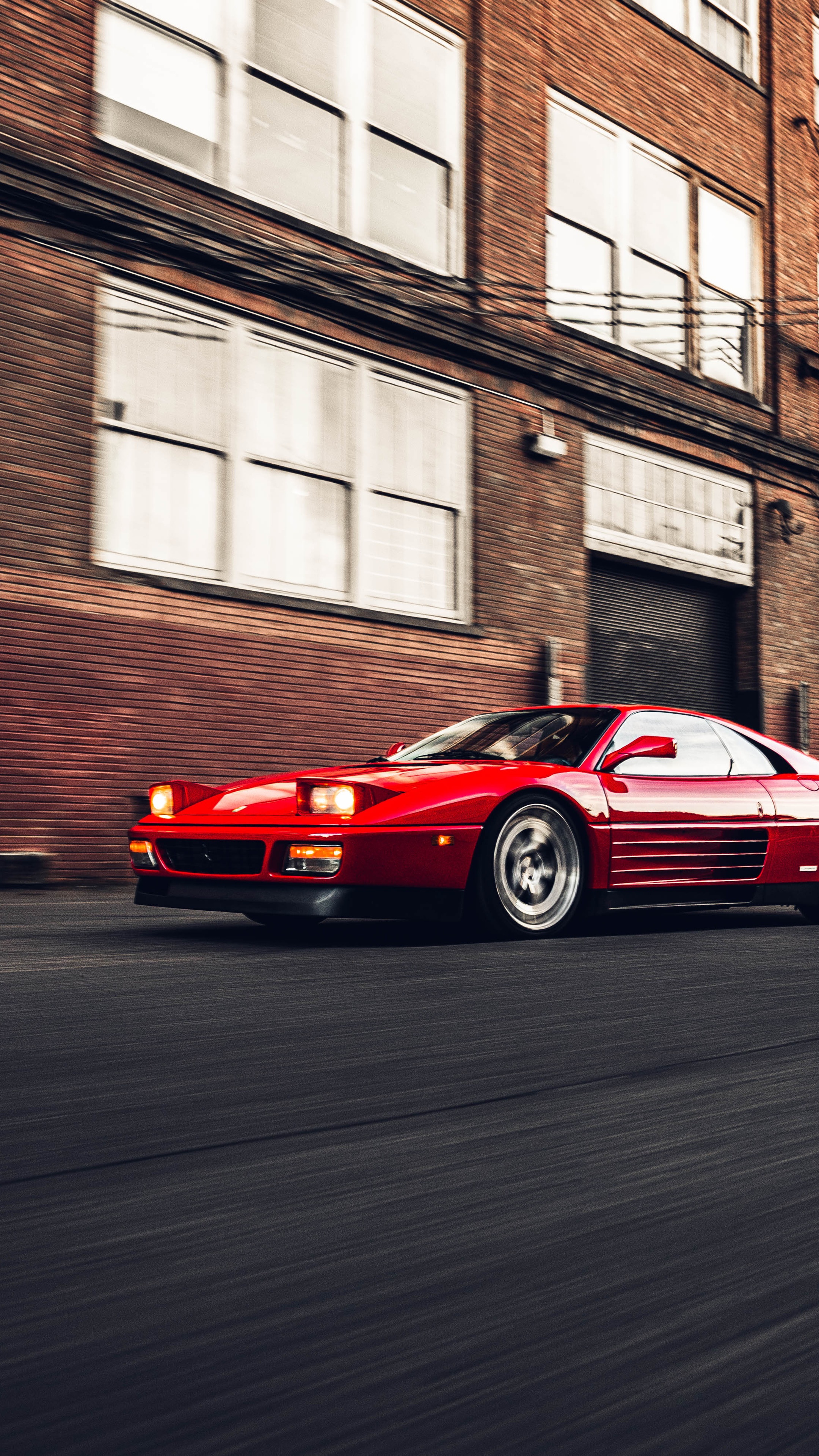 Red Ferrari 348 driving on a street HD Phone Wallpaper