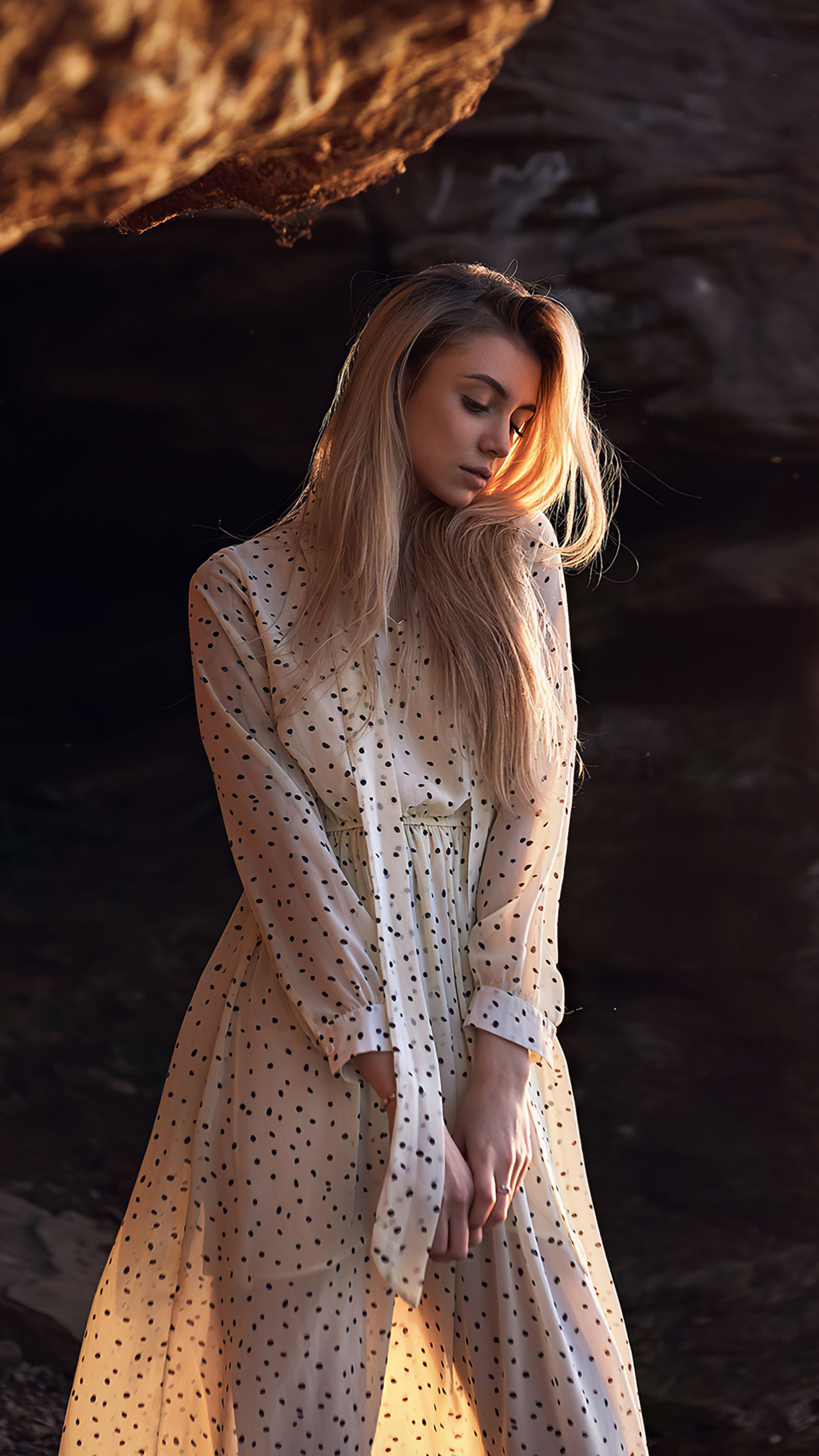 Woman in polka dot dress in rocky cove HD Phone Wallpaper