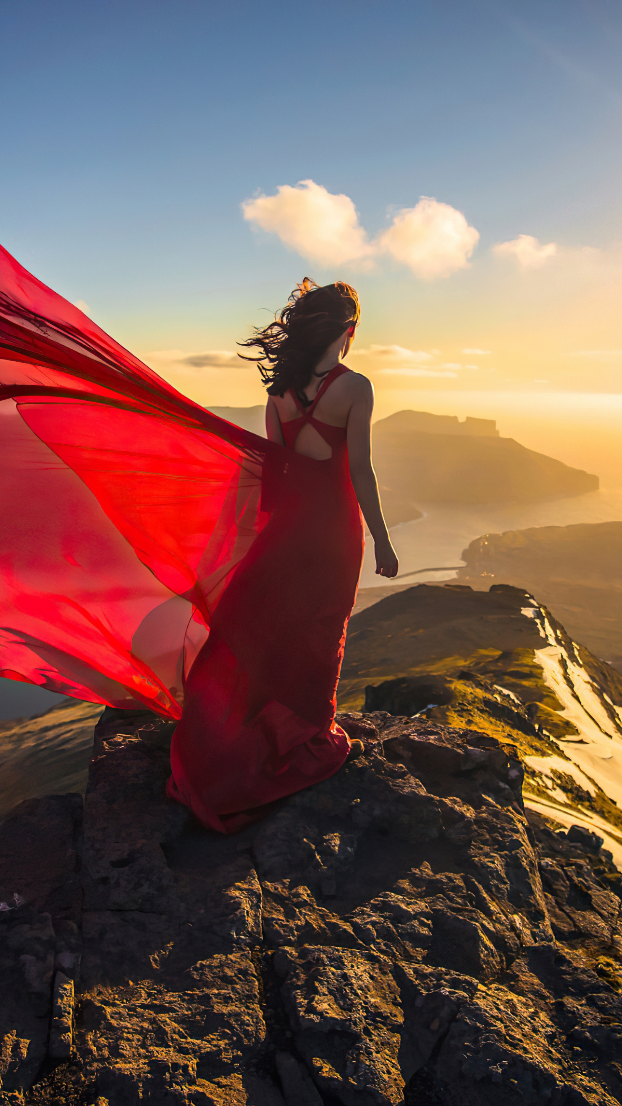 Woman in red dress on mountain peak at sunset 4K HD Phone Wallpaper