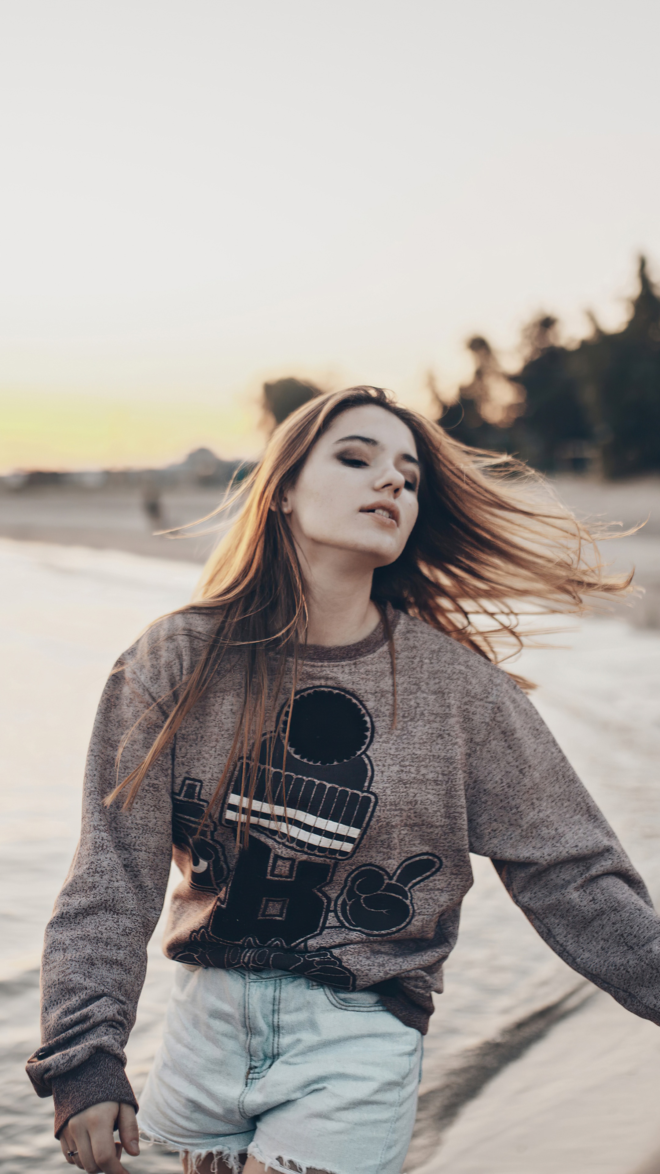 Girl on a beach at sunset HD Phone Wallpaper
