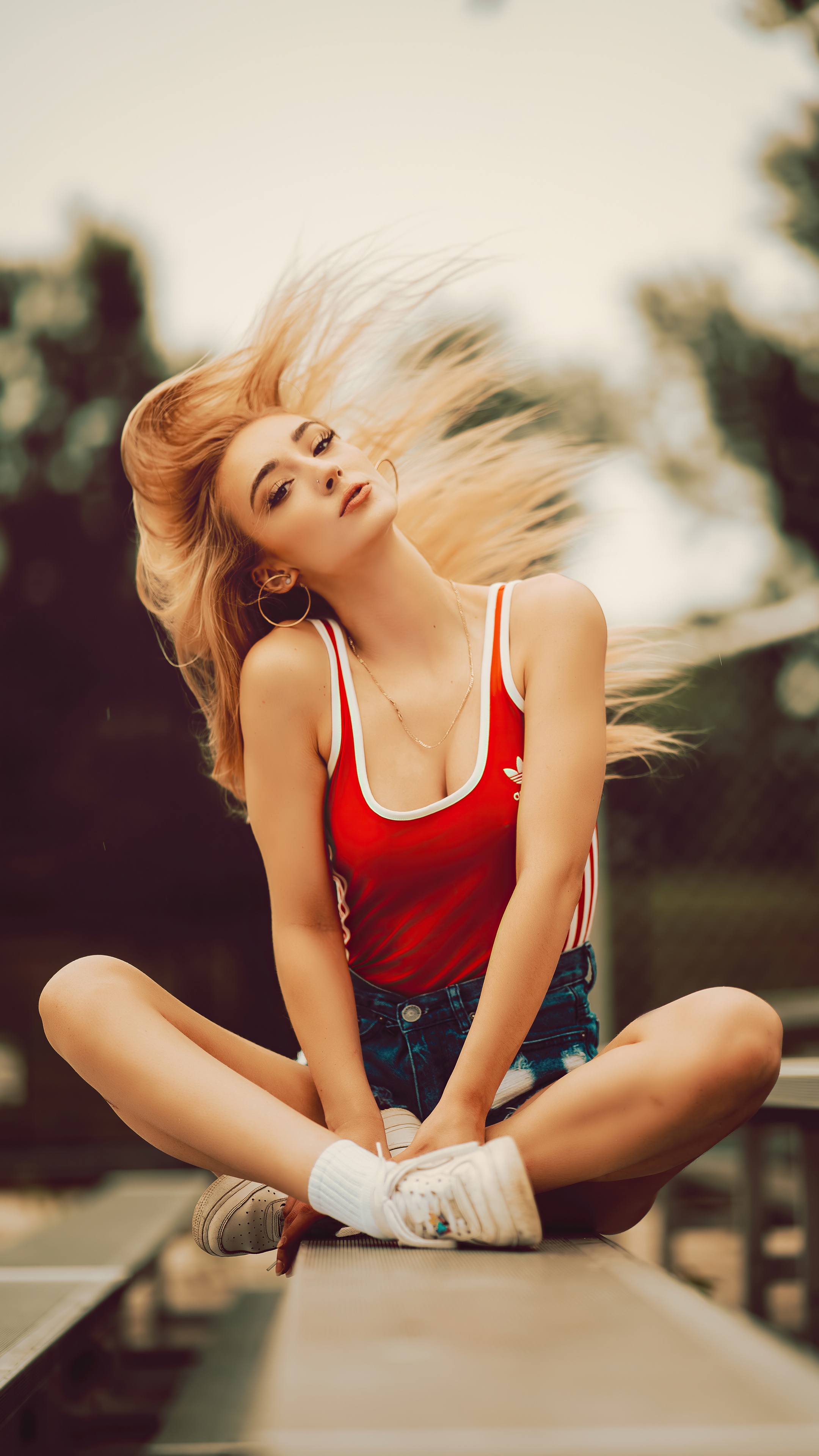 Blonde model in red tank top and denim shorts HD Phone Wallpaper