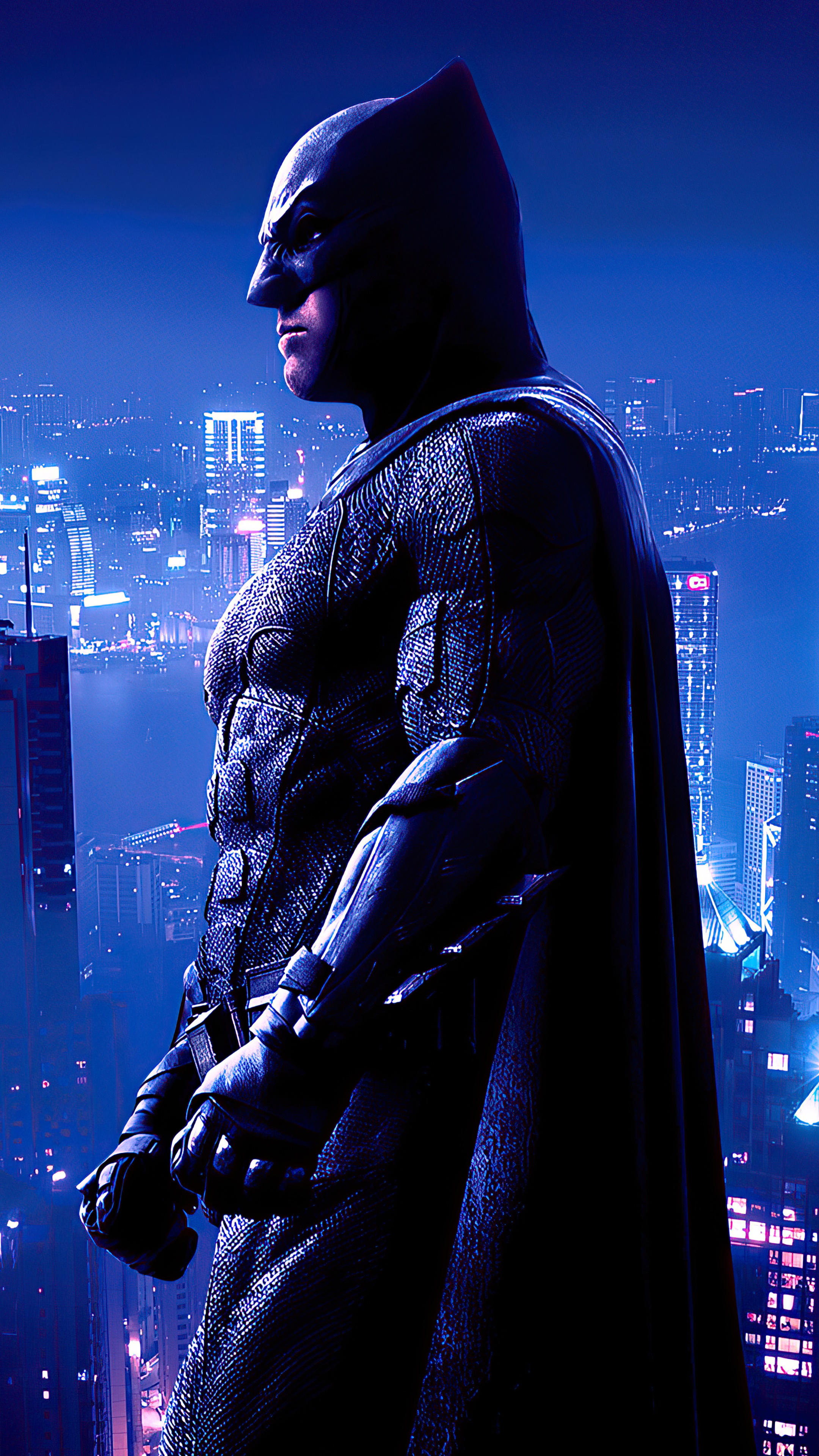 Batman standing in front of a city skyline HD Phone Wallpaper