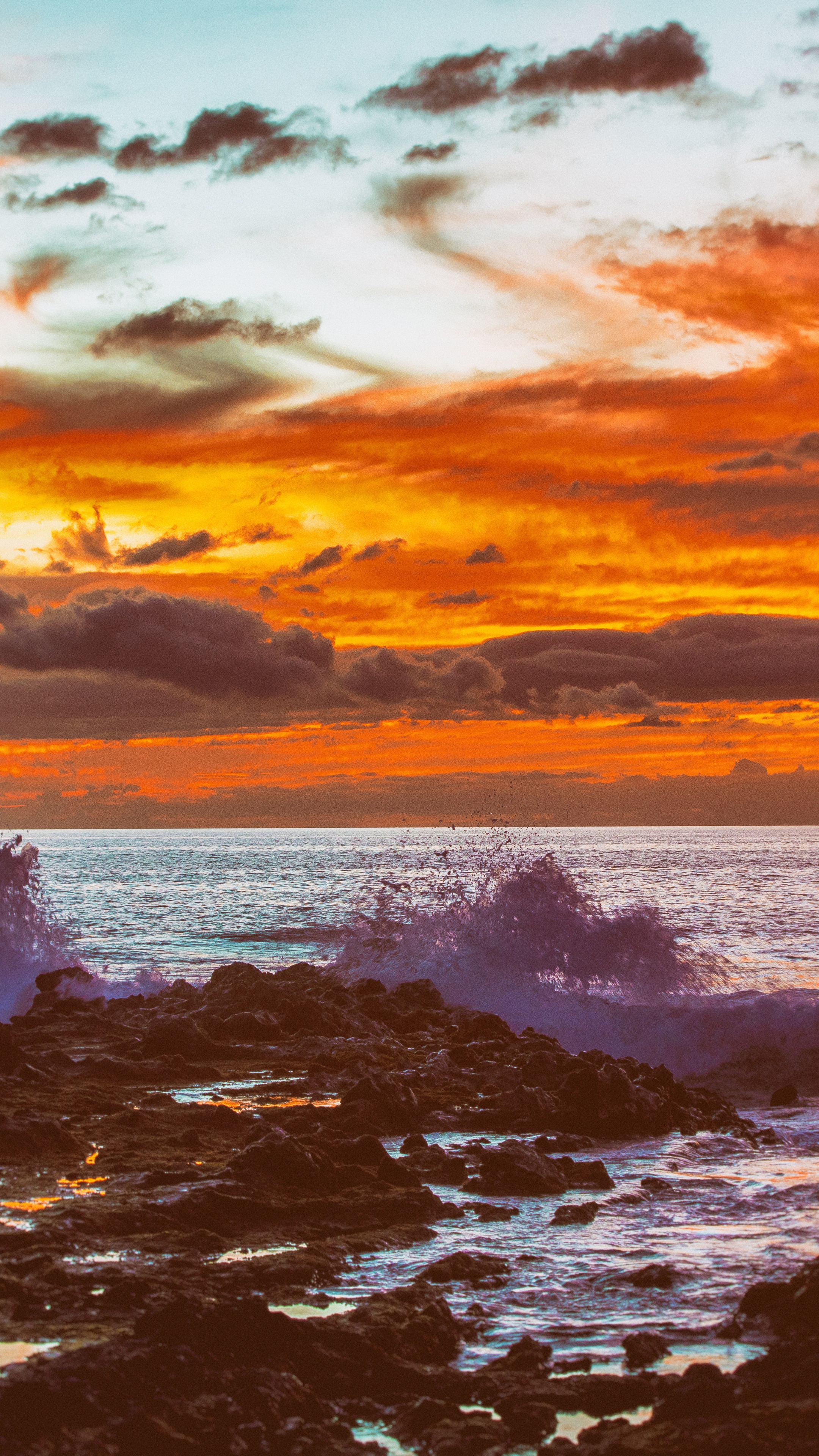 Sunset over the ocean with waves crashing on rocks HD Phone Wallpaper