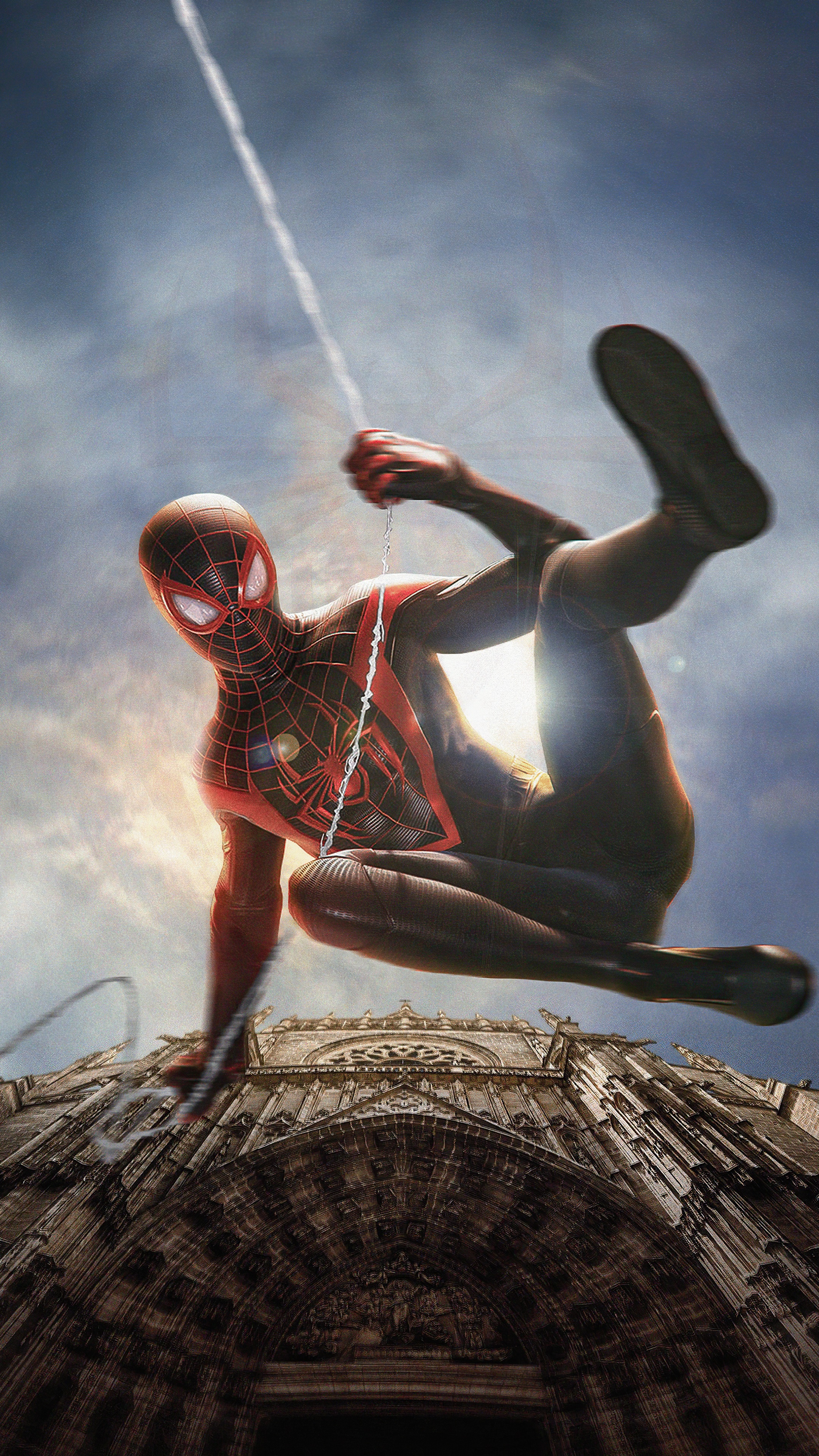 Spider-Man Miles Morales swinging in front of a cathedral HD Phone Wallpaper